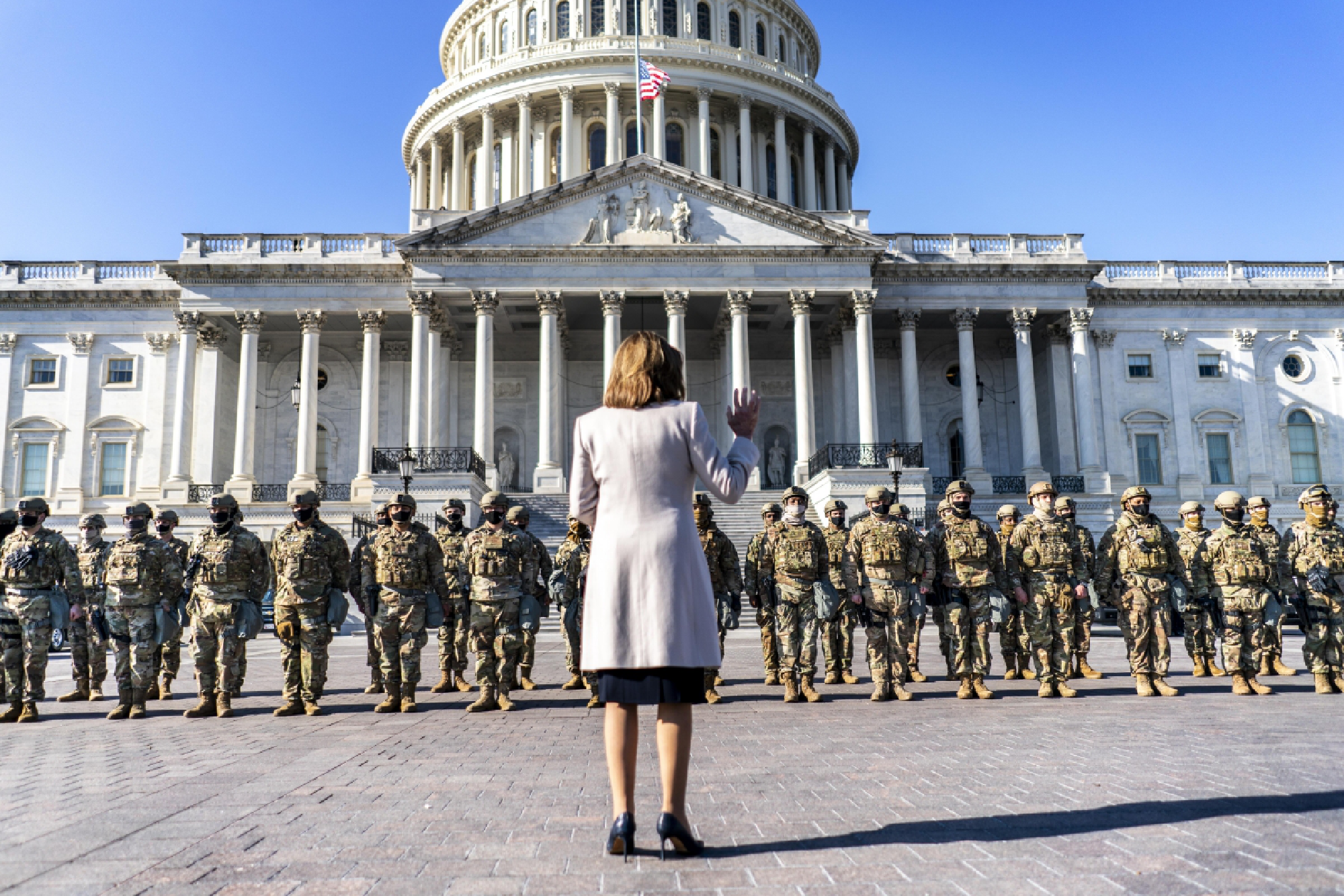 House Speaker Nancy Pelosi greets the National Guard troops occupying and surrounding the newly fenced-in Capitol Complex in Washington on Wednesday. MUST CREDIT: Washington Post photo by Melina Mara