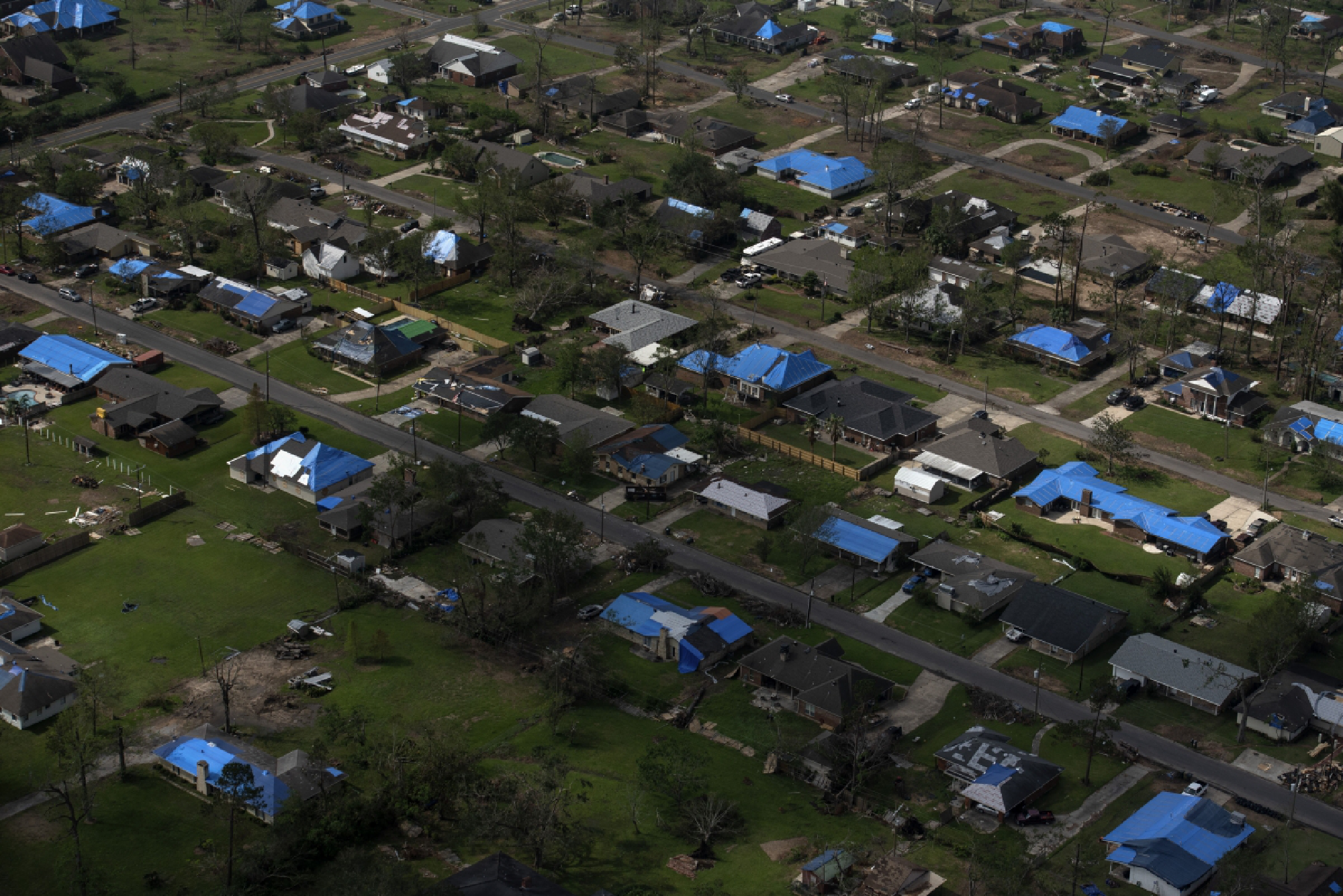 Tarps cover homes after Hurricane Laura and Hurricane Delta landed in southwest Louisiana on Oct. 11. MUST CREDIT: Photo by Callaghan O'Hare for The Washington Post.
