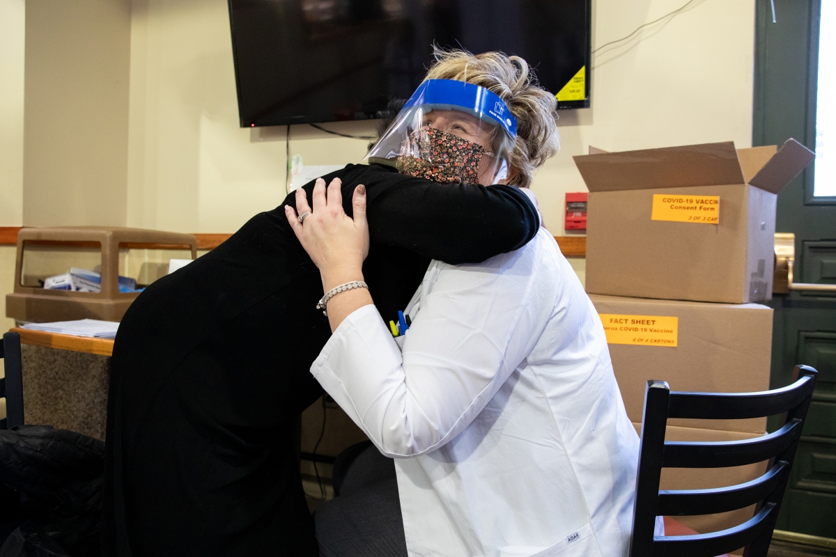 Ramona Cohen hugs pharmacy manager Kathy Hershey after Hershey gave her a vaccine against covid-19 on Jan. 15, 2021 in Washington D.C. MUST CREDIT: photo for The Washington Post by Amanda Andrade-Rhoades.