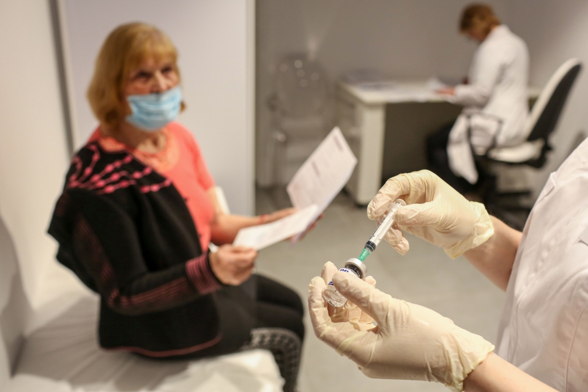 A nurse prepares to administer a dose of the the Sputnik V vaccine in a covid-19 vaccination center inside the GUM department store in Moscow on Jan. 20, 2021. MUST CREDIT: Bloomberg photo by Andrey Rudakov.