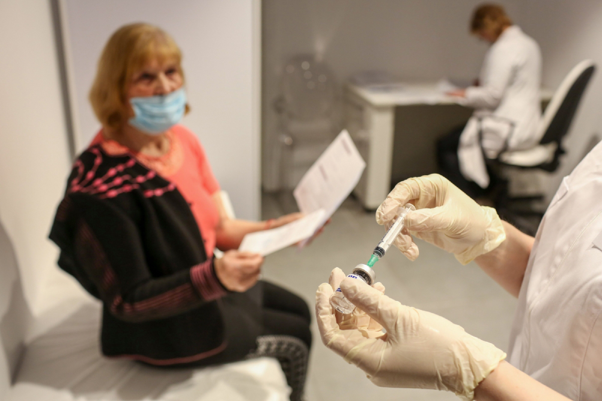 A nurse prepares to administer a dose of the the Sputnik V vaccine in a covid-19 vaccination center inside the GUM department store in Moscow on Jan. 20, 2021. MUST CREDIT: Bloomberg photo by Andrey Rudakov.