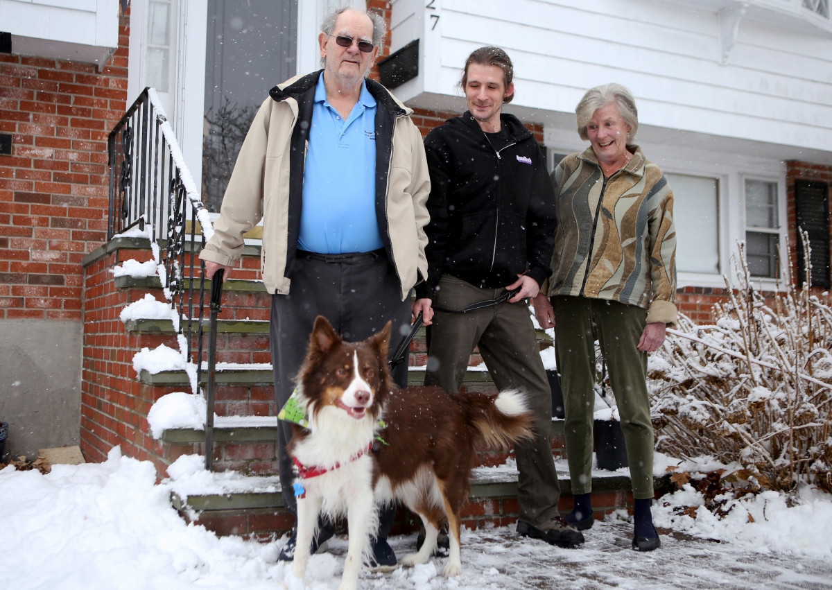 From left, Richard, Jonathan, and Christine Burlingame stand with their dog, Blaze, outside of Jonathan's home in Canton, Mass. MUST CREDIT: Photo for The Washington Post by Olivia Falcigno
