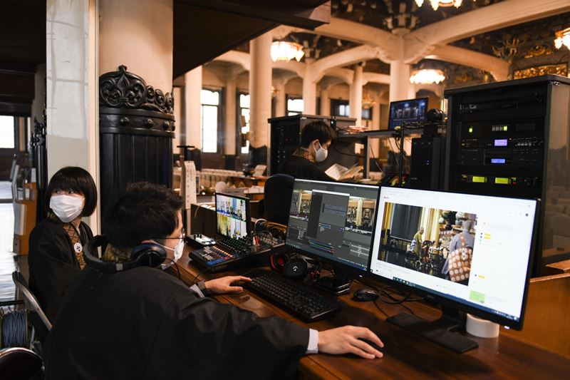 Staff operate computers during a live broadcast of an online memorial service at Tsukiji Hongwanji temple in Tokyo. MUST CREDIT: Bloomberg photo by Noriko Hayashi