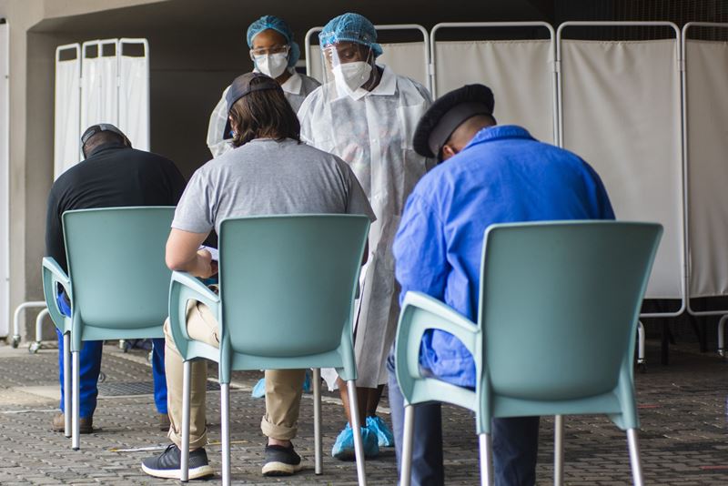 Health workers register patients at a Covid-19 testing station in Johannesburg, South Africa, on Feb. 10, 2021. MUST CREDIT: Bloomberg photo by Waldo Swiegers.