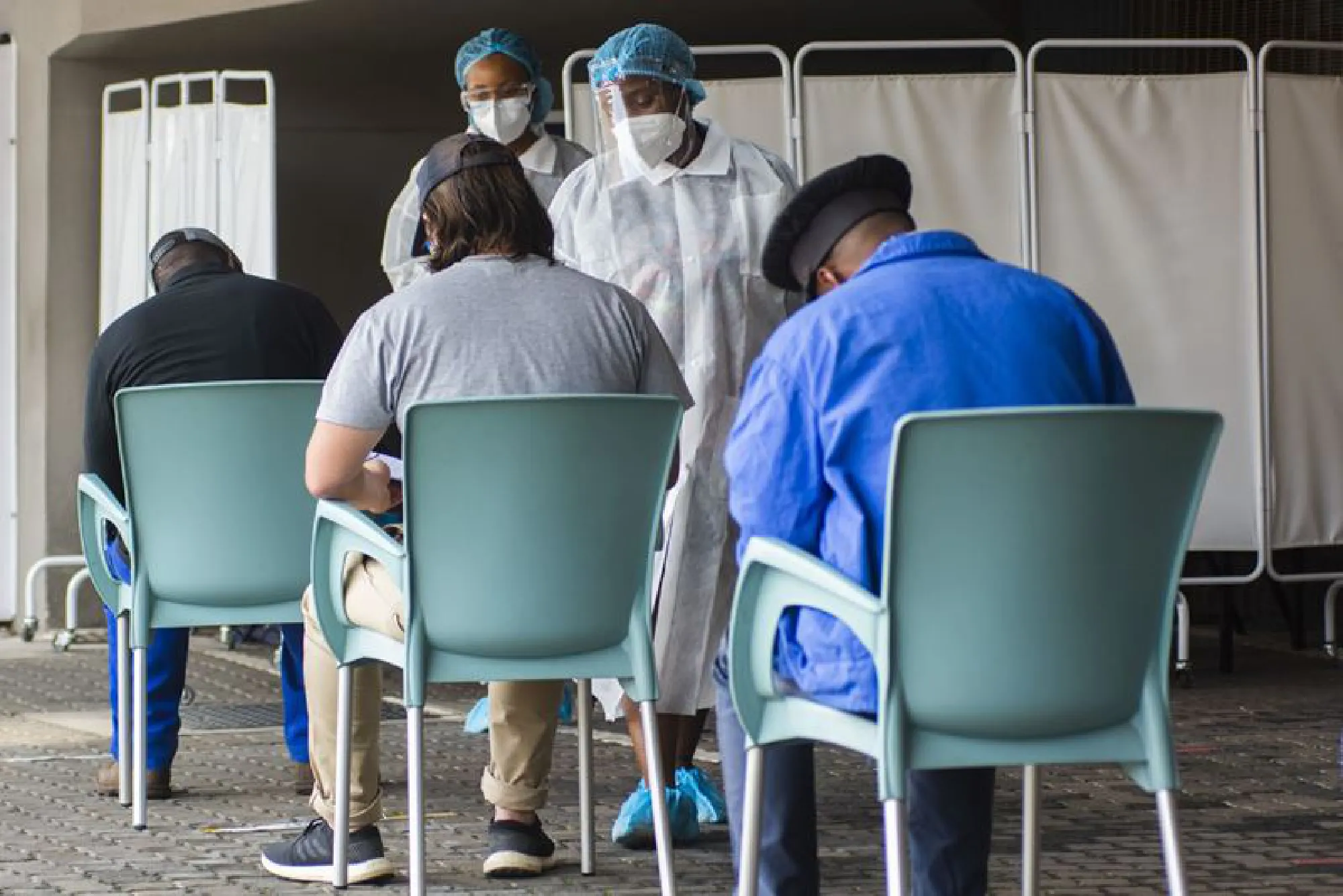 Health workers register patients at a Covid-19 testing station in Johannesburg, South Africa, on Feb. 10, 2021. MUST CREDIT: Bloomberg photo by Waldo Swiegers.