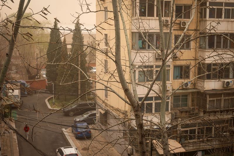 A residential building shrouded in haze in Beijing on March 15, 2021. MUST CREDIT: Bloomberg photo by Yan Cong