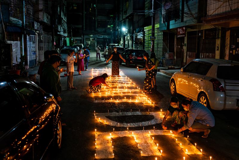 Residents light candles as part of a protest in Sanchaung to pray for those who have died during the protests. MUST CREDIT: photo for The Washington Post.