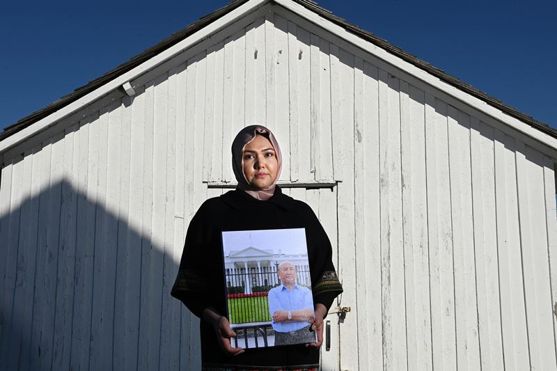 Subi Mamat Yuksel holds a photo of her father, Mamat Abdullah, who has been sentenced to life in prison in China. MUST CREDIT: Washington Post photo by Matt McClain.