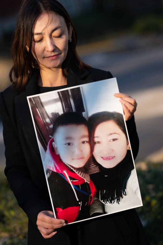 Kalbinur Gheni holds a photo of her sister, Renagul Gheni, and her nephew, Radiljan Abla. MUST CREDIT: Washington Post photo by Sarah L. Voisin.