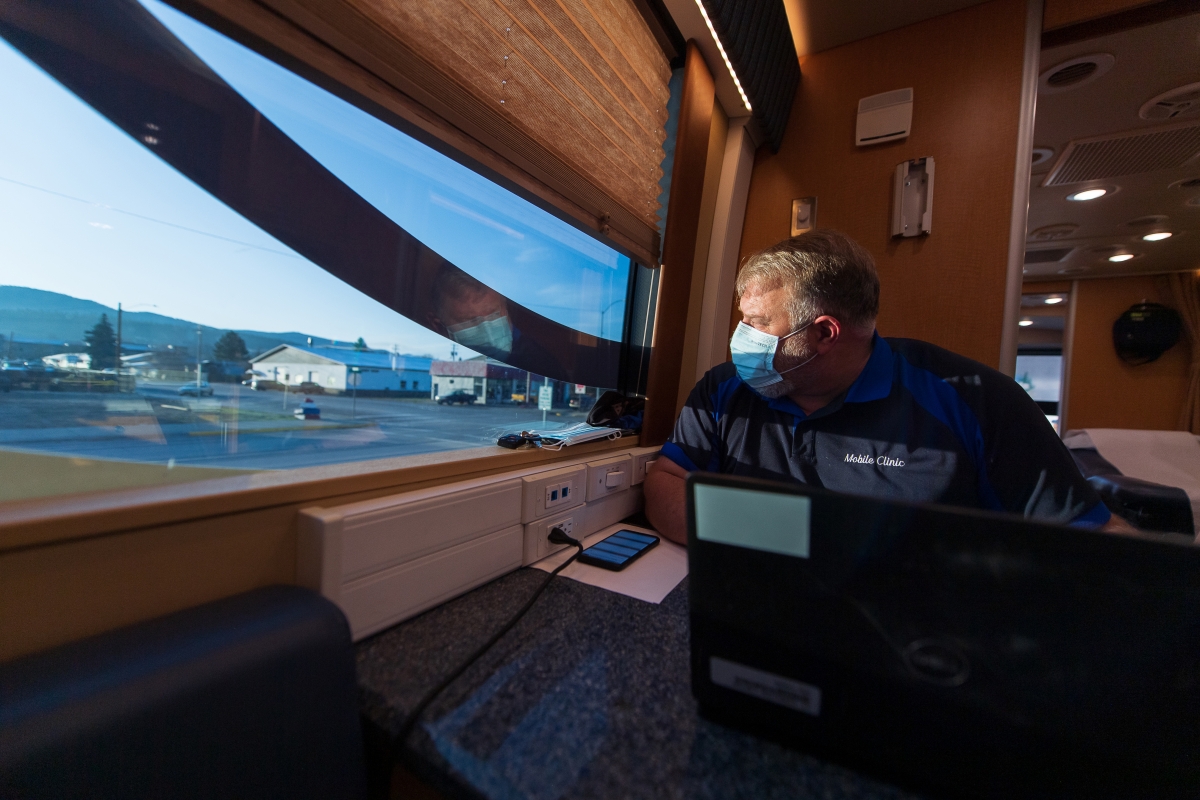 VA emergency room nurse Mark Sheldon, a Gulf War combat Marine, looks out the window of the mobile clinic in Libby, Mont., on March 30, 2021. Photo by Tony Bynum for The Washington Post