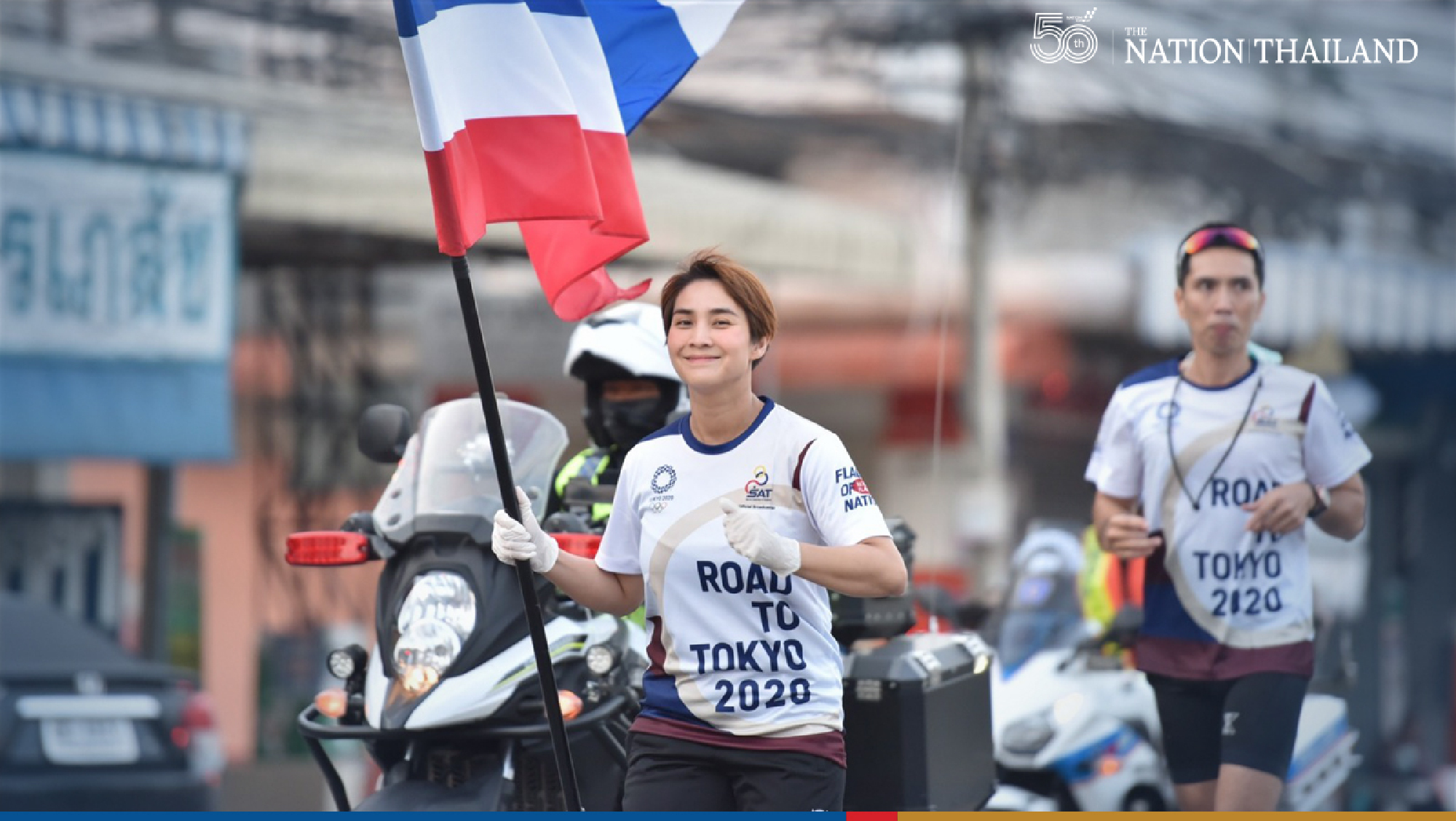 Two former Olympic athletes, Yaowapa Boorapolchai and Manus Boonjumnong, joined the “Flag of Nation” relay on Thursday as the nationwide run reached its 26th day.