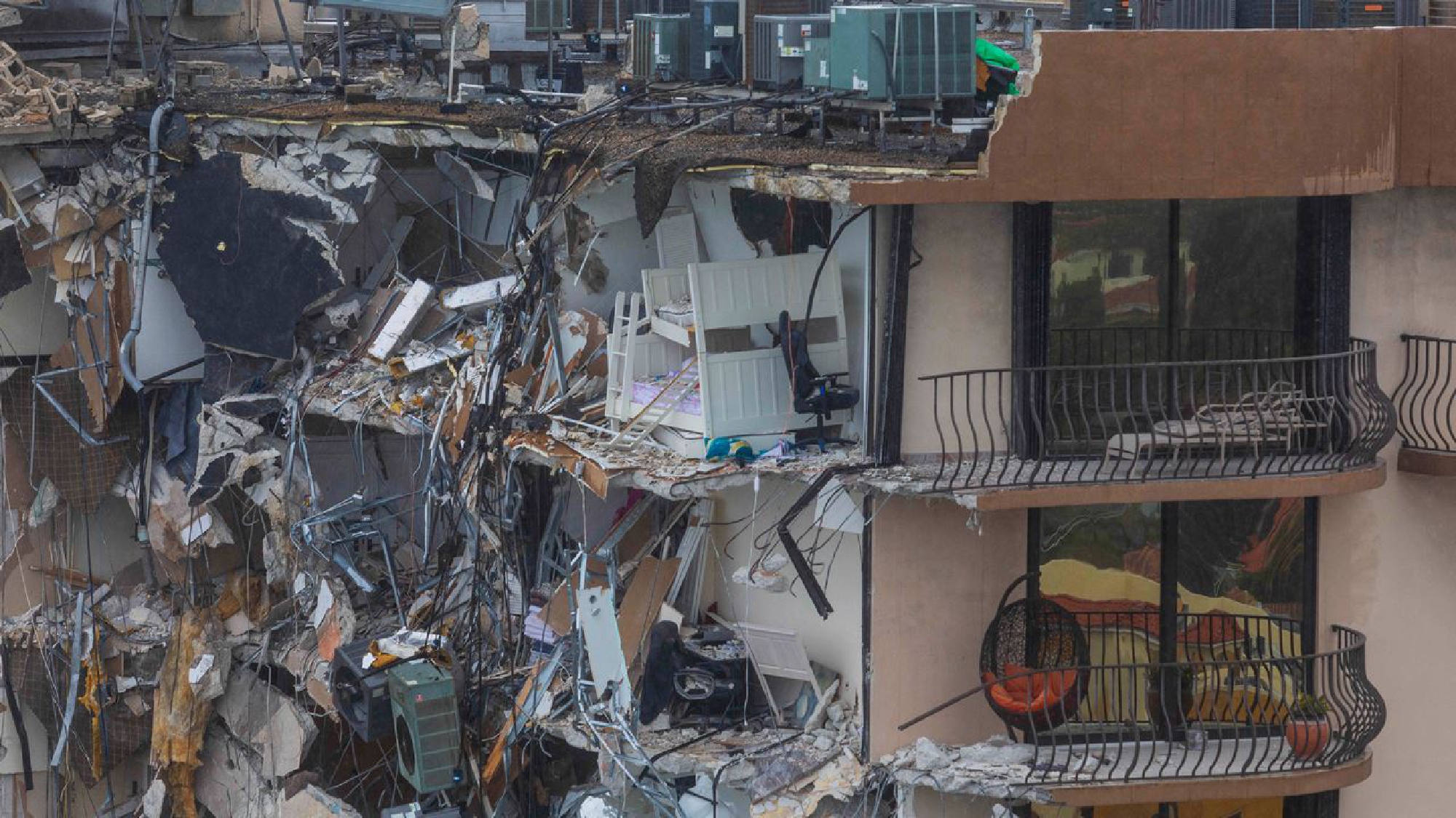 As the Champlain Towers South Condo collapsed, it left behind parts of rooms and furnishings. MUST CREDIT: photo for The Washington Post by Saul Martinez.
