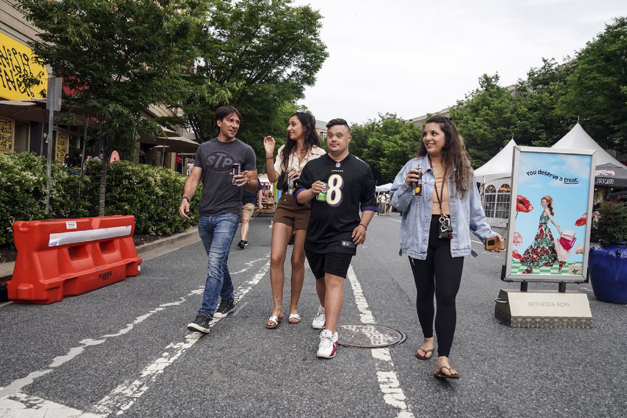 From left, Spiro Tsianakas, Theoni Tsinonis, Nektarios Tsinonis, and Anastasia Kontos stroll along Woodmont Avenue in Bethesda, Md., in June. MUST CREDIT: Washington Post photo by Toni L. Sandys,