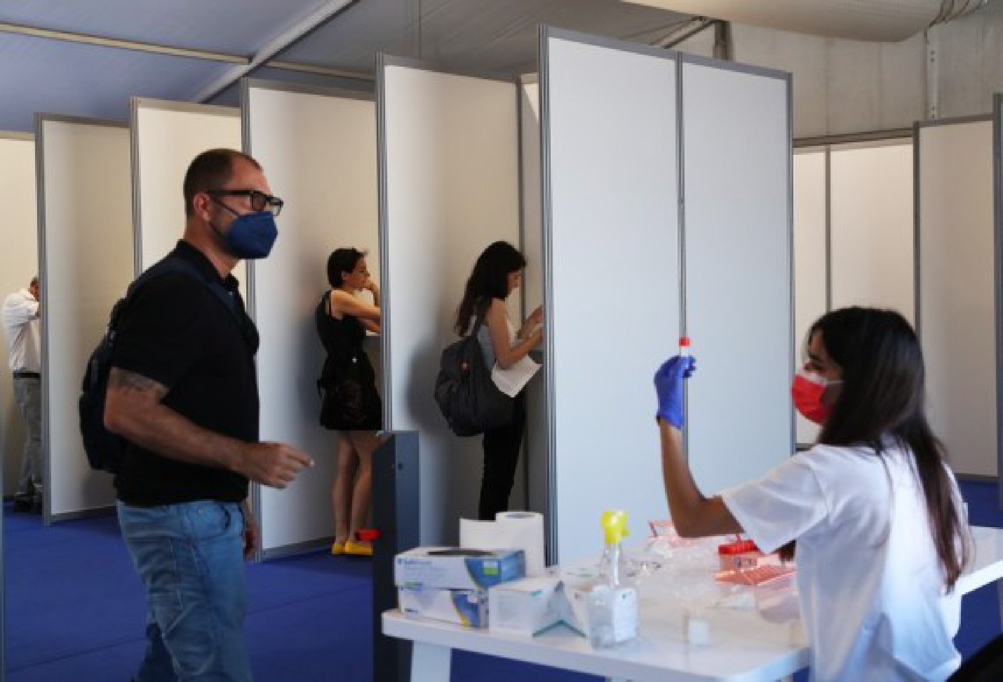 A medical staff member collects saliva samples for COVID-19 test at a tent ahead of the film festival in Cannes, southern France