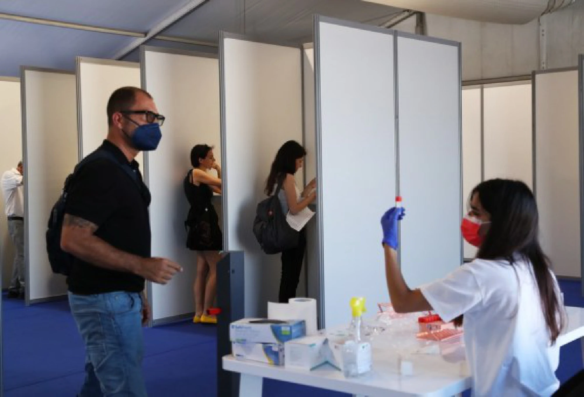 A medical staff member collects saliva samples for COVID-19 test at a tent ahead of the film festival in Cannes, southern France