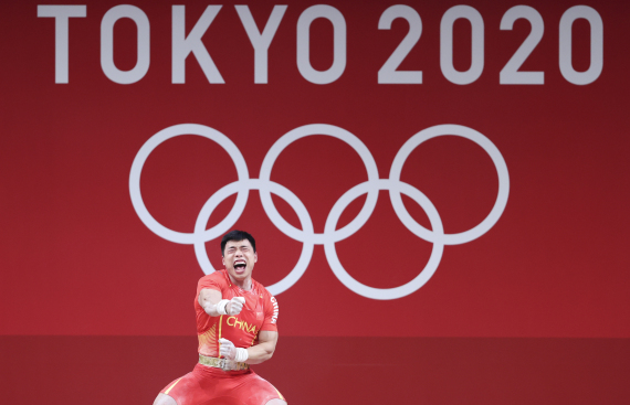 Chen Lijun of China reacts during the men's 67kg weightlifting event of the Tokyo 2020 Olympic Games in Tokyo, Japan, July 25, 2021. 
