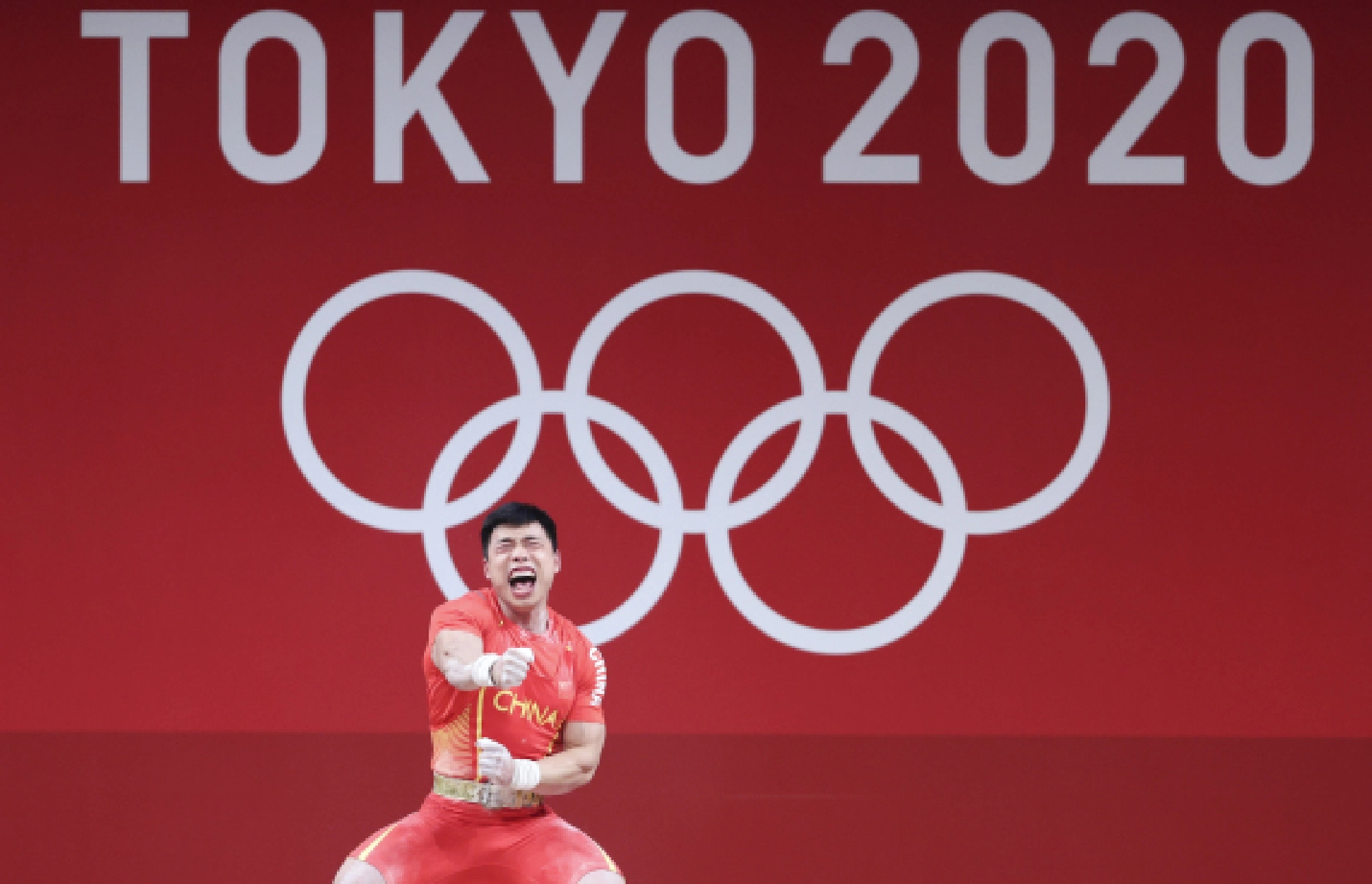 Chen Lijun of China reacts during the men's 67kg weightlifting event of the Tokyo 2020 Olympic Games in Tokyo, Japan, July 25, 2021. 