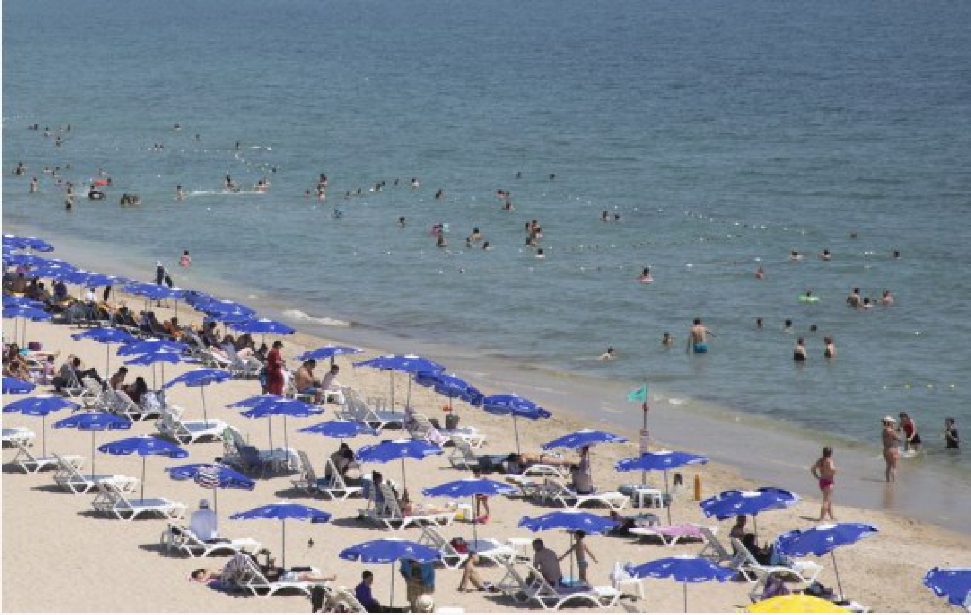 People enjoy leisure time at the seaside in Igneada, a small Turkish resort town of the Black Sea province of Kirklareli bordering Bulgaria, on July 20, 2021.