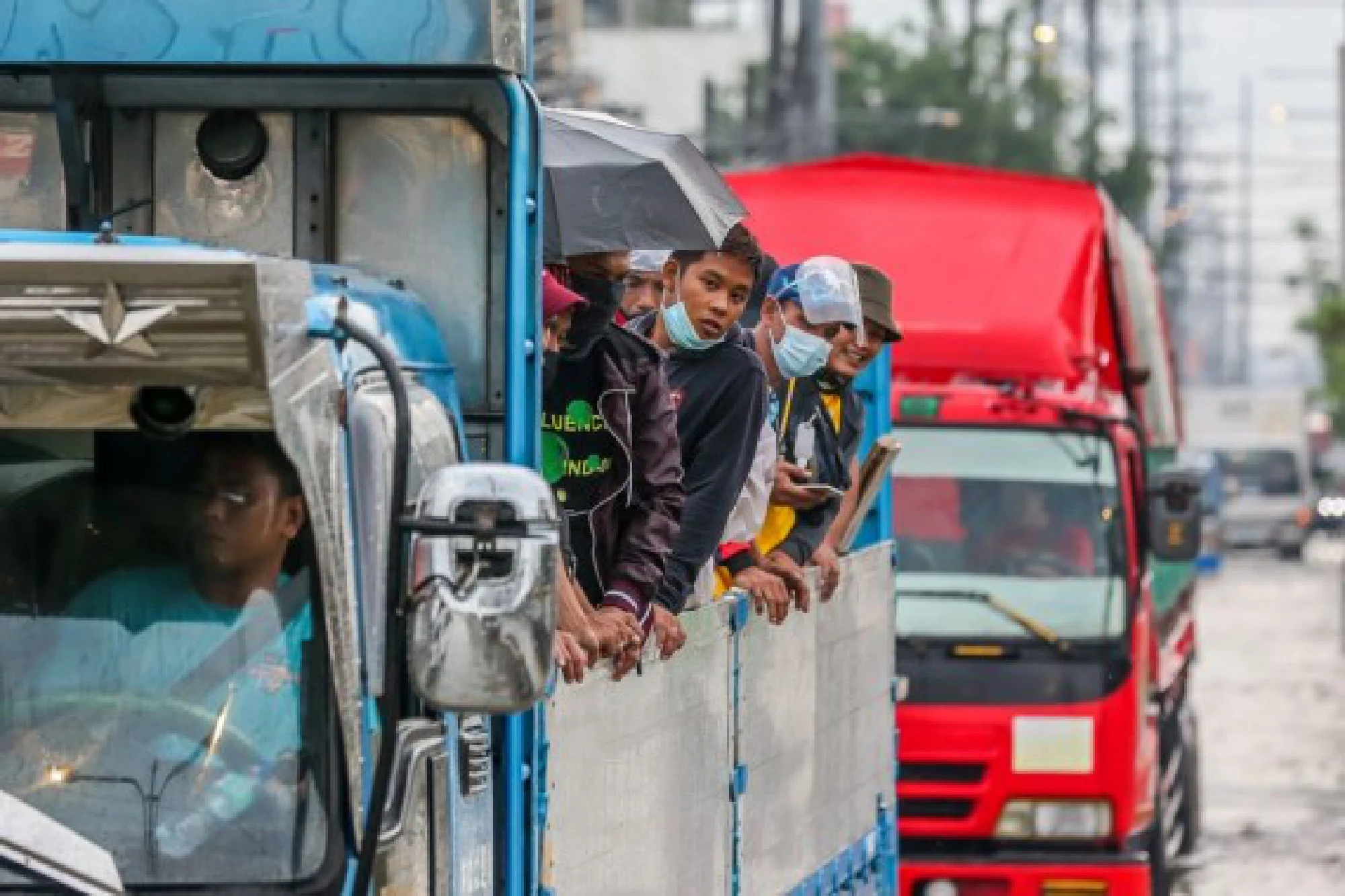 People are seen onboard a truck to avoid the flood brought by heavy monsoon rains in Rizal Province, the Philippines, July 24, 2021. 