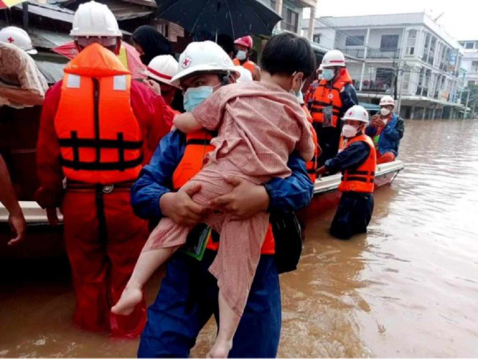 A rescuer evacuates a stranded child in flood-hit Myawaddy town of Kayin State, Myanmar