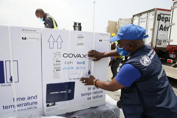 Workers transfer boxes of COVID-19 vaccines arrived at Abidjan International Airport in Abidjan, Cote d'Ivoire, Feb. 26, 2021. 