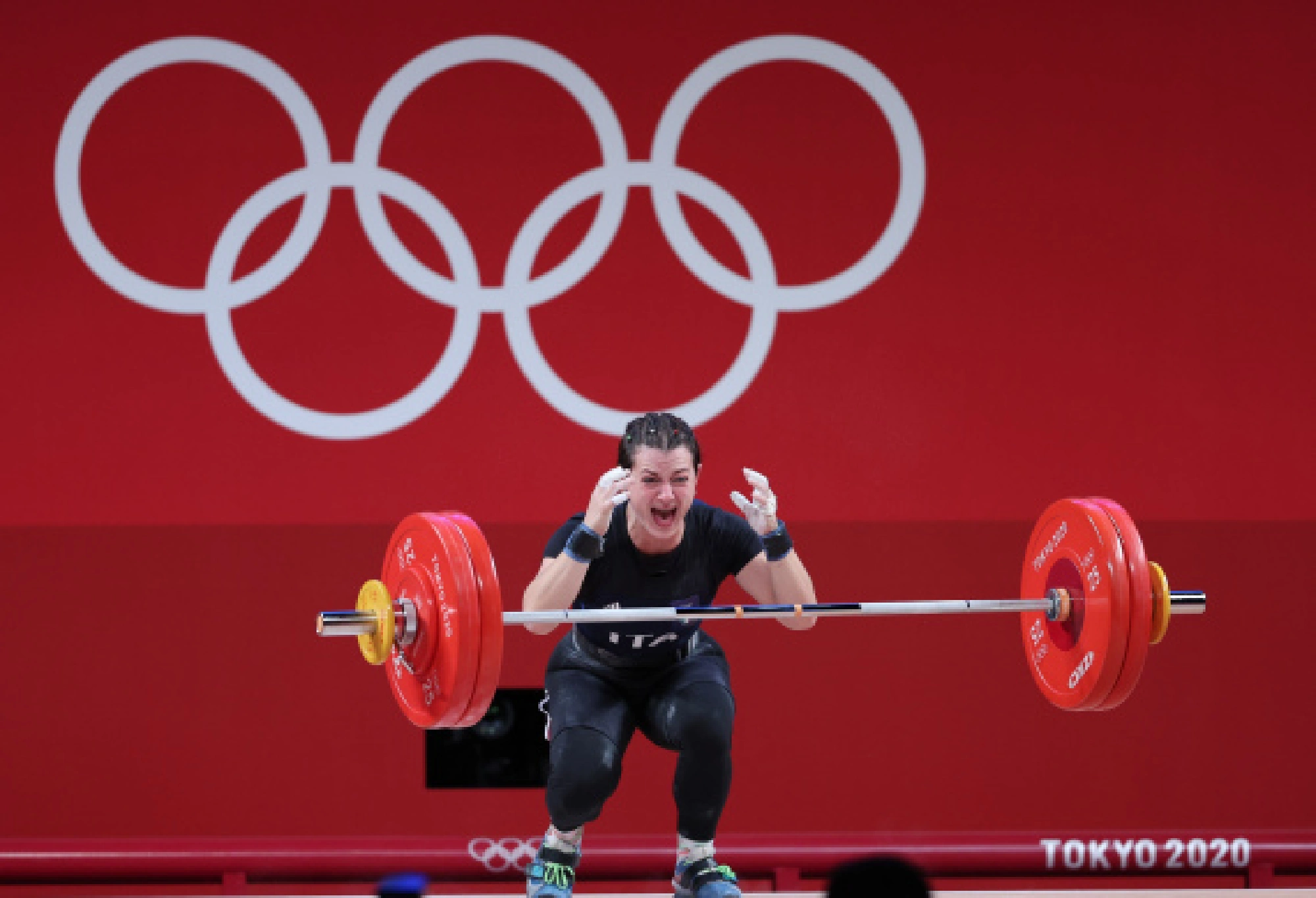 Glorgia Bordignon of Italy reacts during the weightlifting women's 64kg group A match at the Tokyo 2020 Olympic Games in Tokyo, Japan, July 27, 2021.
