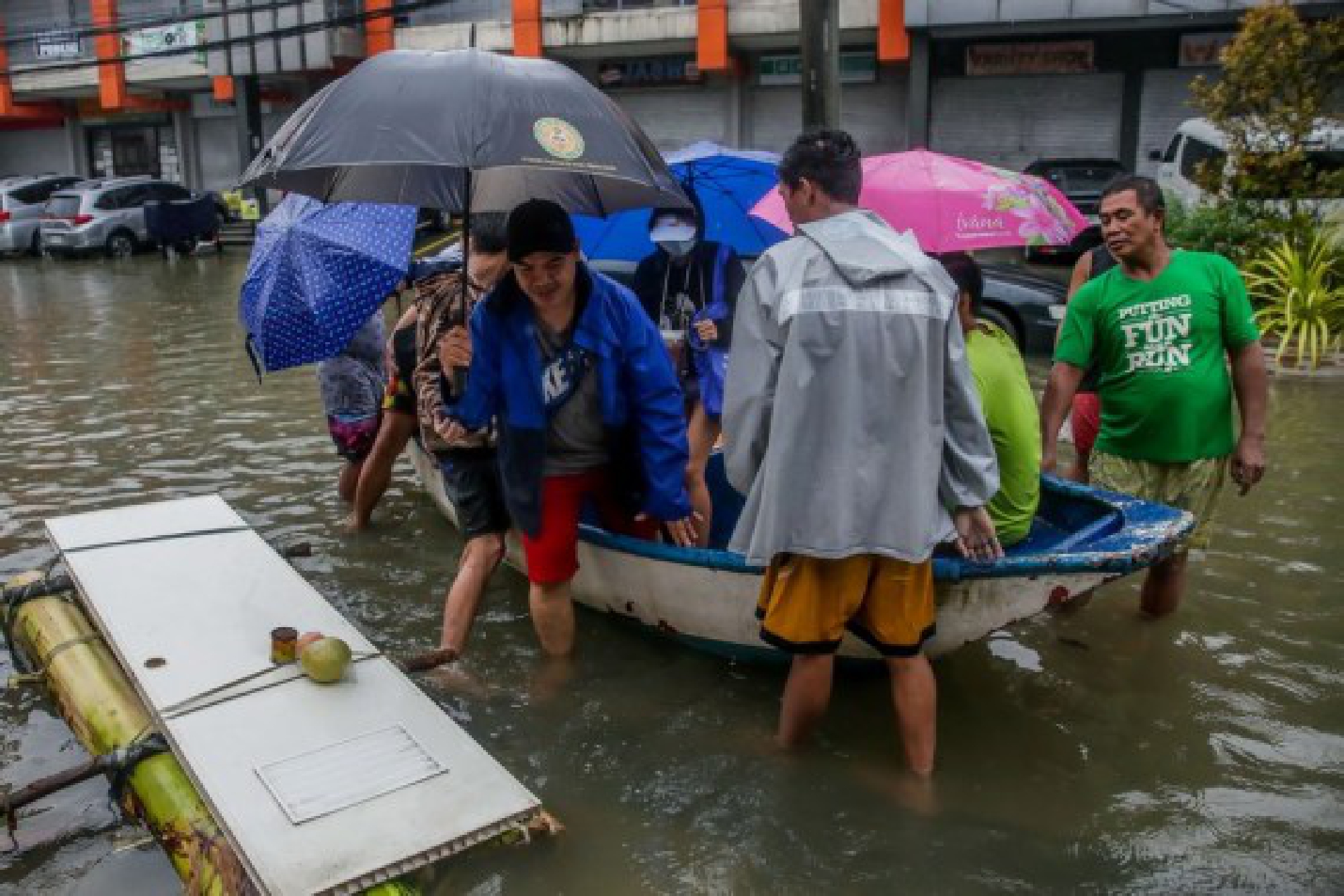 People are seen on a boat to avoid the flood brought by heavy monsoon rains in Rizal Province, the Philippines, July 24, 2021.