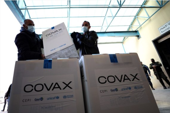 Workers arrange boxes of COVID-19 vaccines to be kept at the Palestinian Authority's storage facility in Salem village, east of the West Bank city of Nablus, March 17, 2021. 
