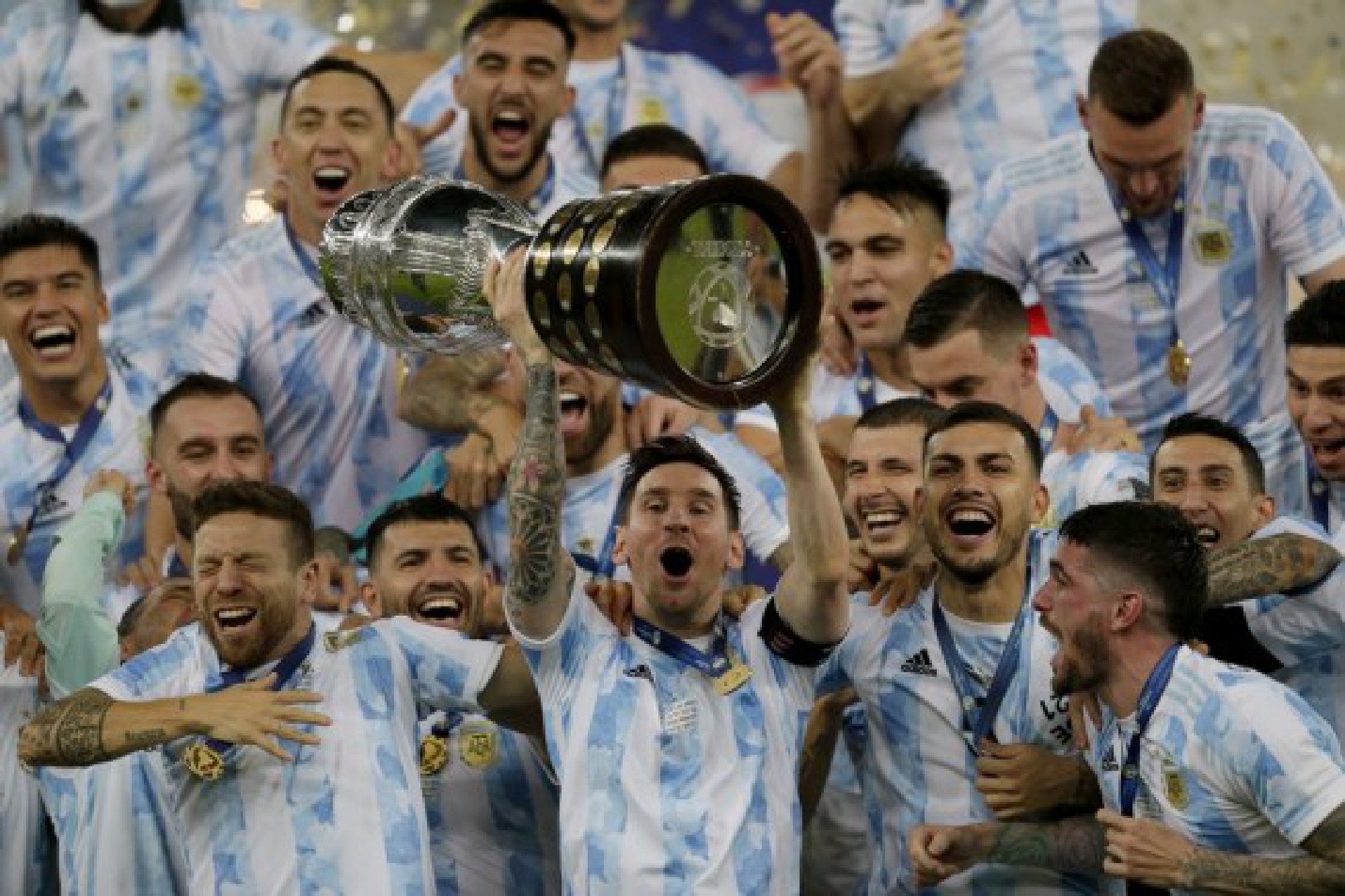 Messi (C) lifts the Copa America trophy aloft after Argentina won the 2021 tournament, beating Brazil in the final in Rio de Janeiro on July 10, 2021
