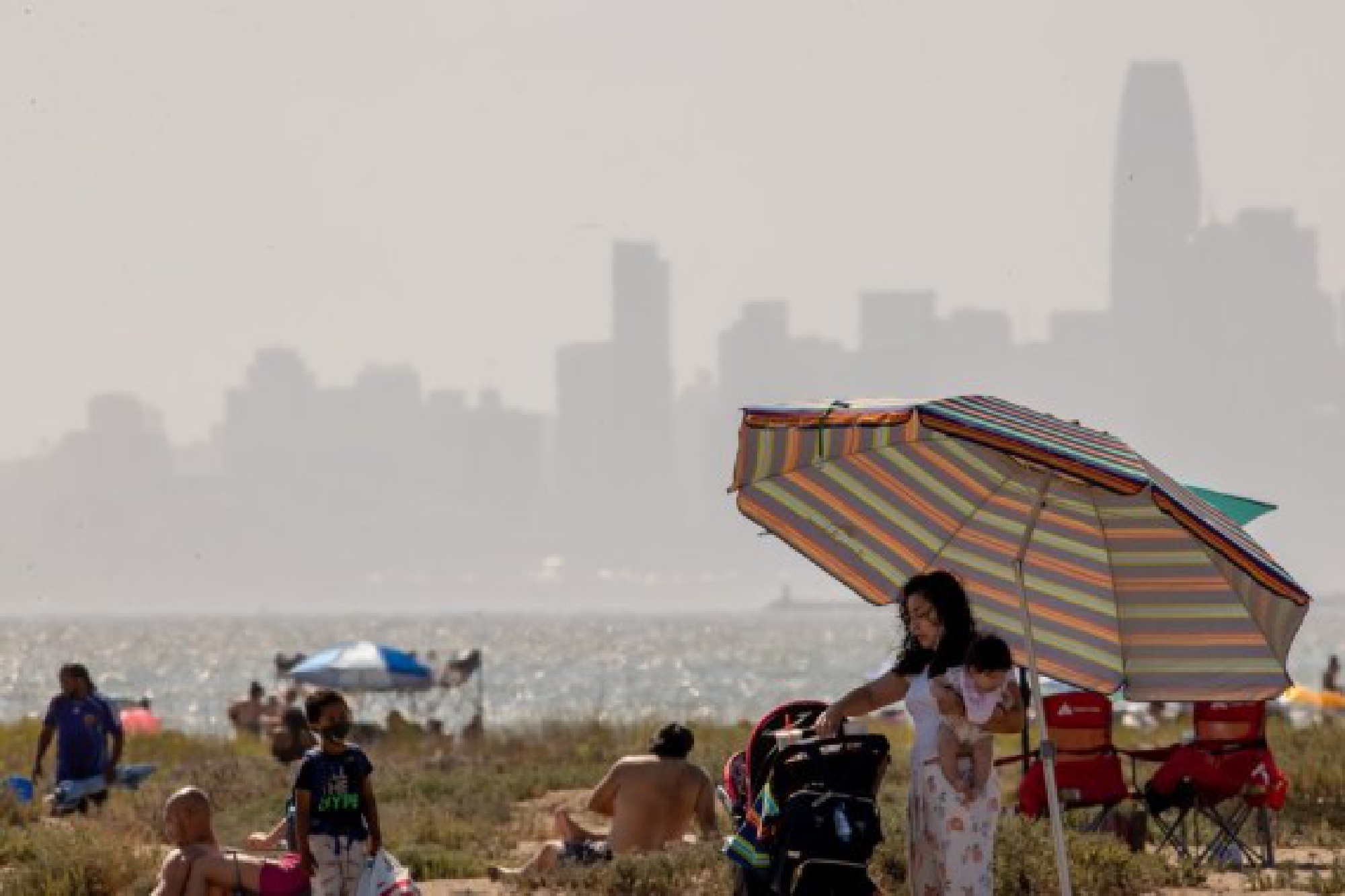 People cool themselves at the beach in Alameda County, California, the United States,