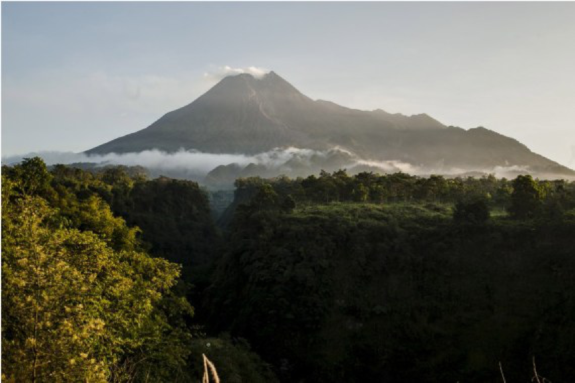 Photo taken on July 1, 2021 shows white smokes spewing from Mount Merapi, seen at Cangkringan village, Sleman district, Yogyakarta of Indonesia.