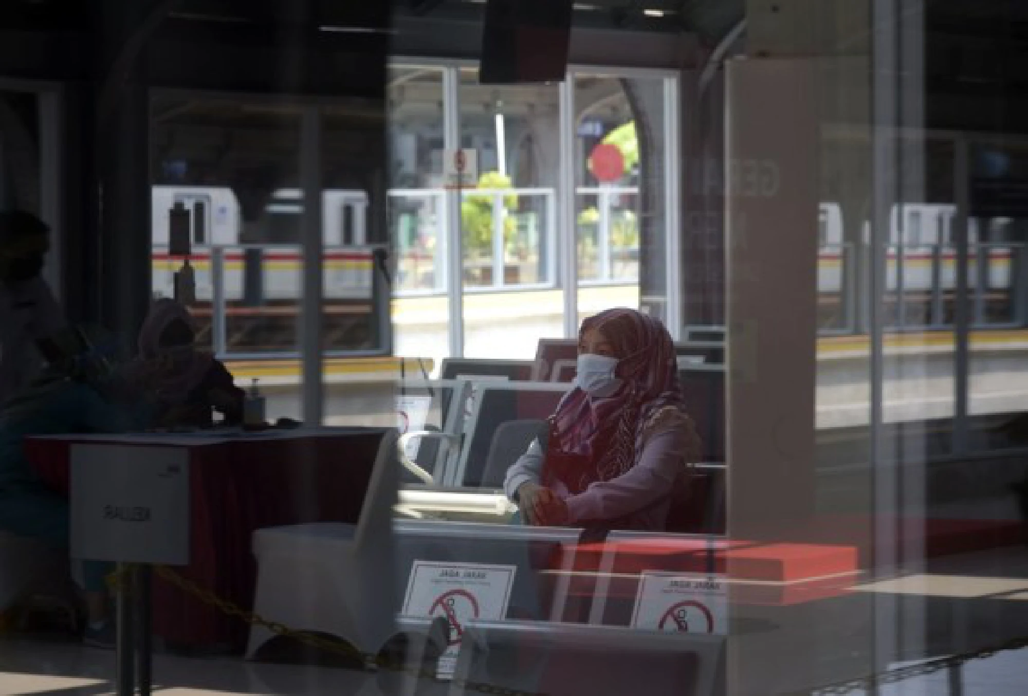 A woman stays for observation after receiving a dose of COVID-19 vaccine in Jakarta, Indonesia,