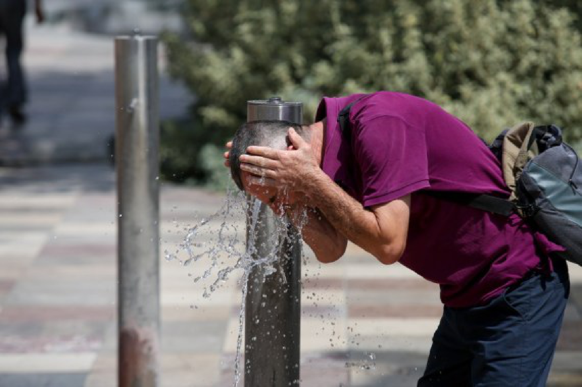 A man cools off in fountains at Skanderbeg Square in the center of capital Tirana, Albania, July 29, 2021.