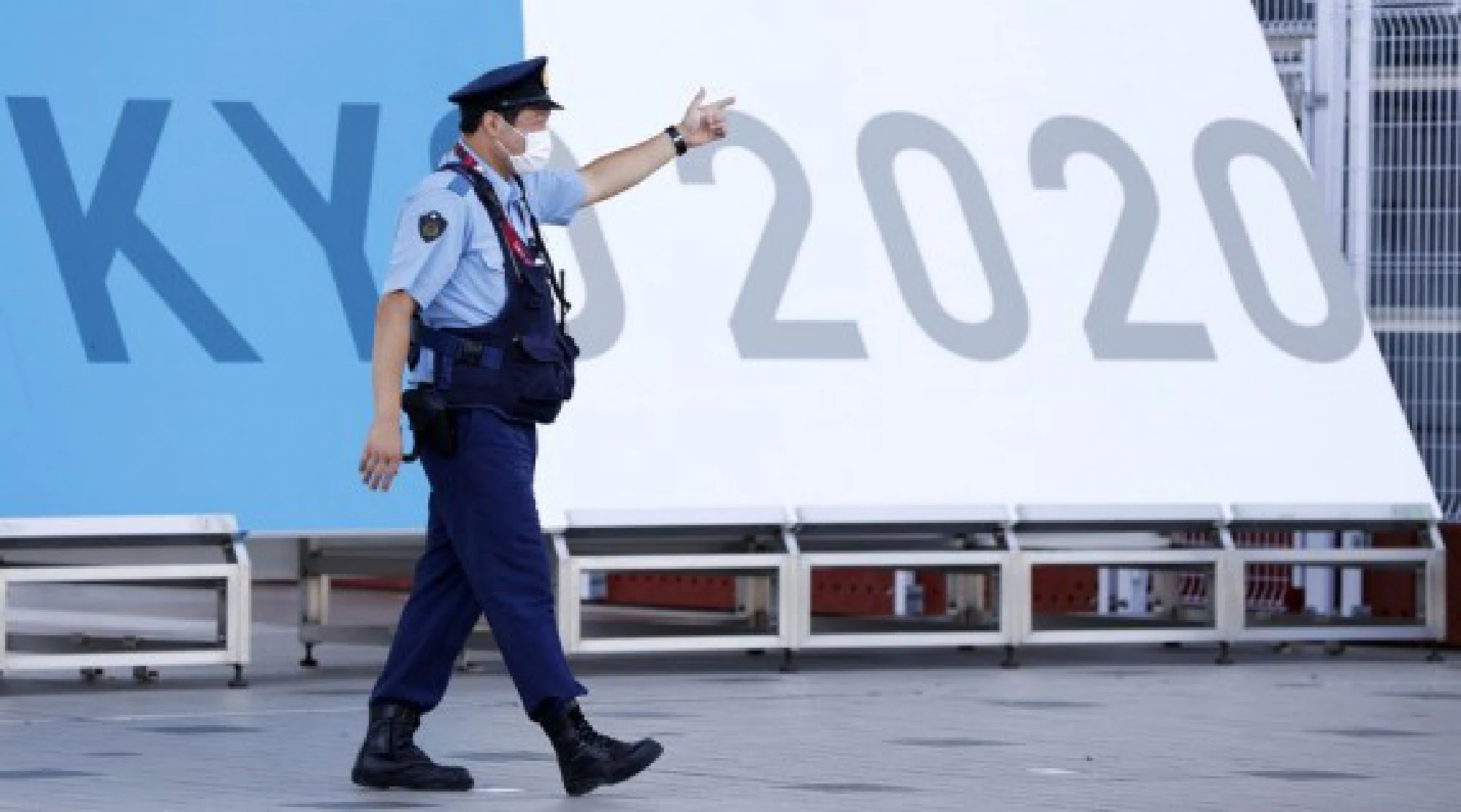 A police officer works at the entrance of the Main Press Center (MPC) of Tokyo 2020 Olympic Games in Tokyo, Japan
