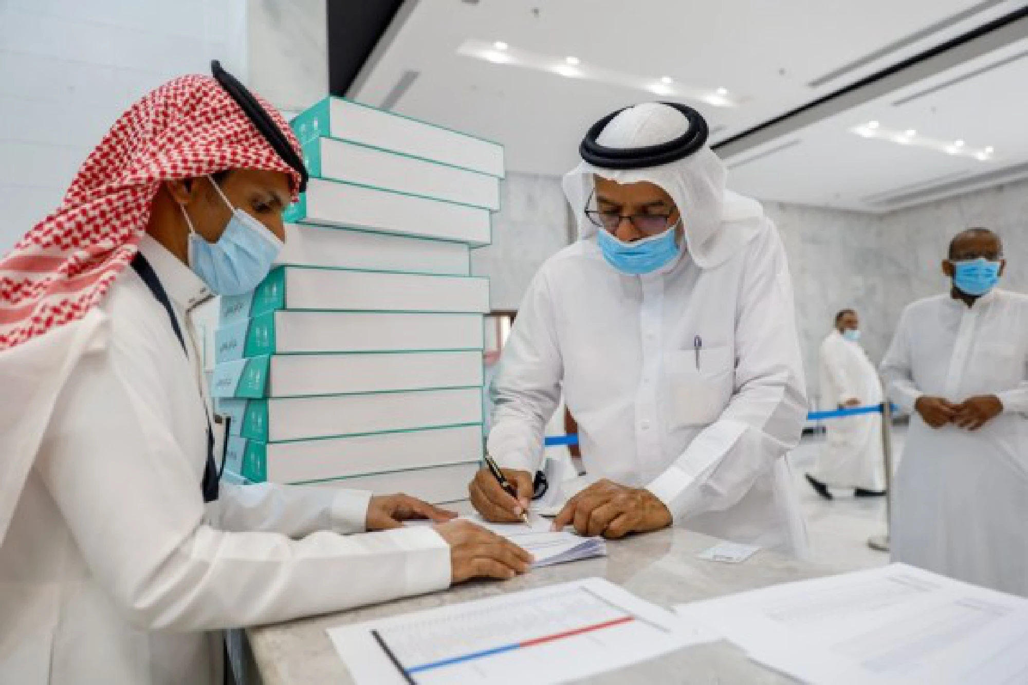 A staff member issues NFC-enabled smart cards with built-in personal information to pilgrims in Mecca, Saudi Arabia, on July 15, 2021. The Saudi government used the latest information technologies to help control the spread of COVID-19 during the Hajj season. 