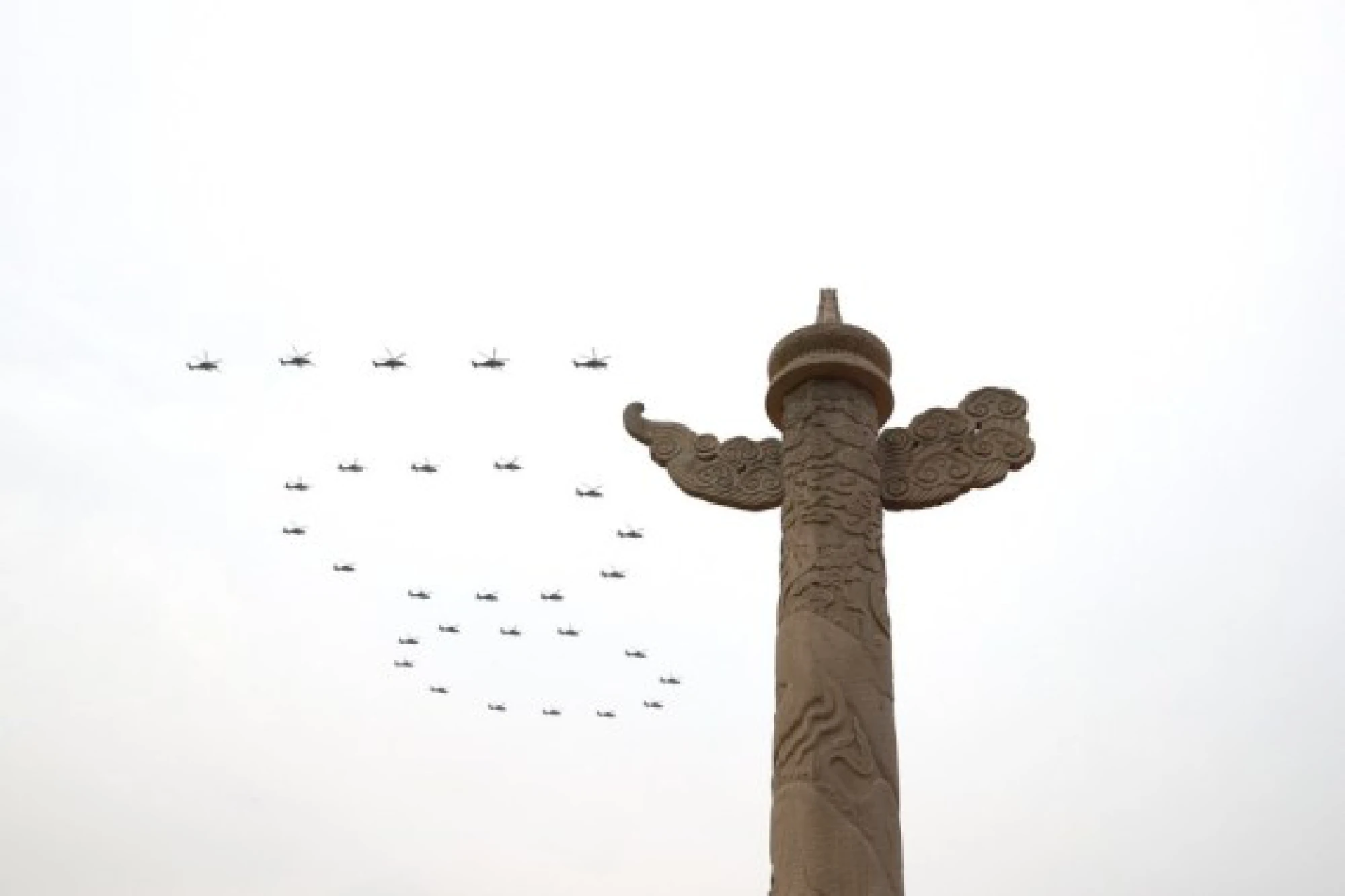 Helicopters fly over Tian'anmen Square in the formation of "100" ahead of a grand gathering celebrating the Communist Party of China (CPC) centenary at Tian'anmen Square in Beijing, capital of China, July 1, 2021.