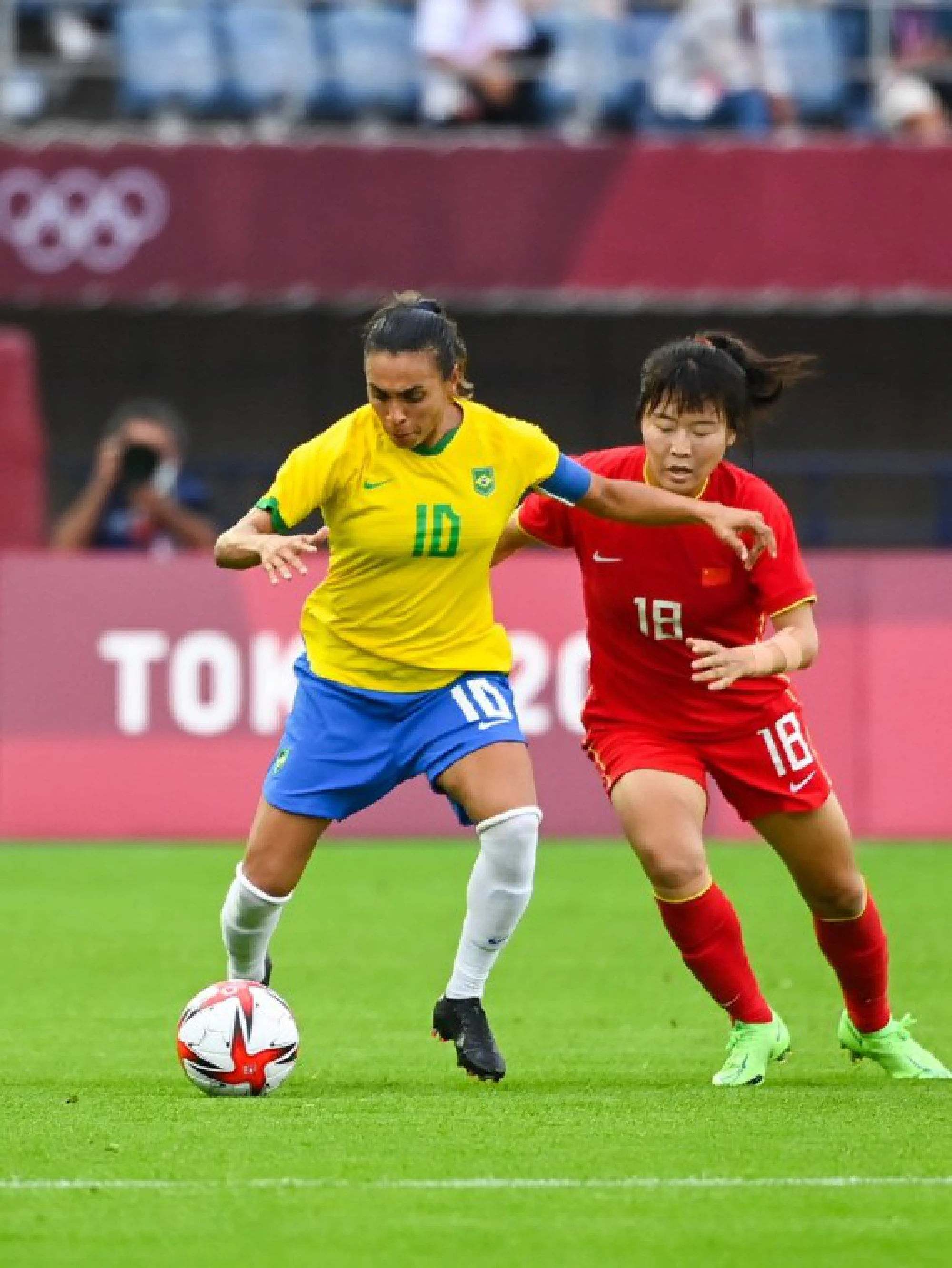 Marta (L) of Brazil vies with Wurigumula of China during Tokyo 2020 women's football group F match between China and Brazil in Miyagi, Japan, July 21, 2021. 