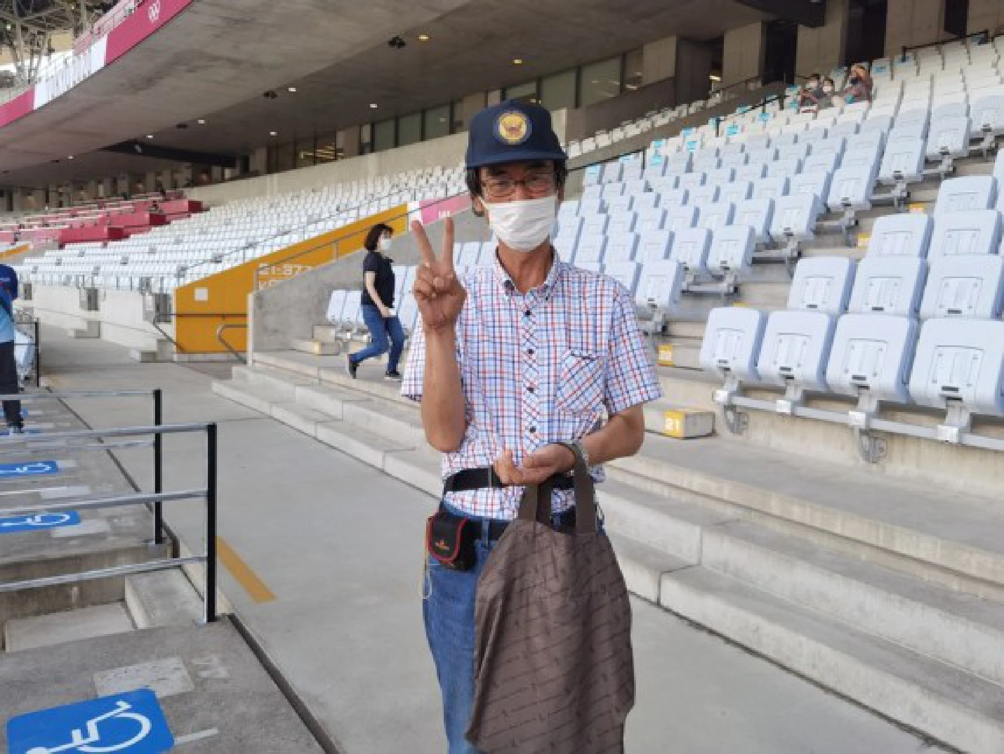 Spectator Masayuki Hobo posts for photos at the Miyagi Stadium before the Tokyo 2020 women's football match between China and Brazil in Miyagi, Japan