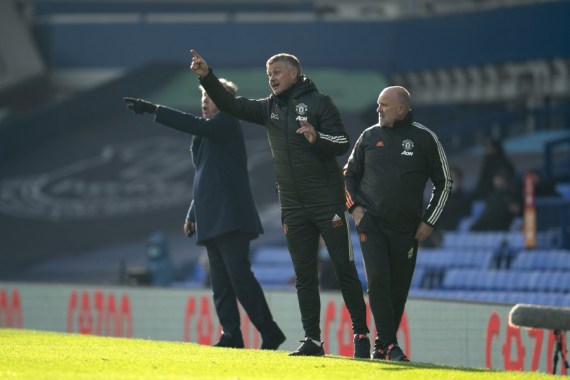 Manchester United's manager Ole Gunnar Solskjaer (C) makes his instructions from the touchline during the Premier League match against Everton at Goodison Park Stadium in Liverpool