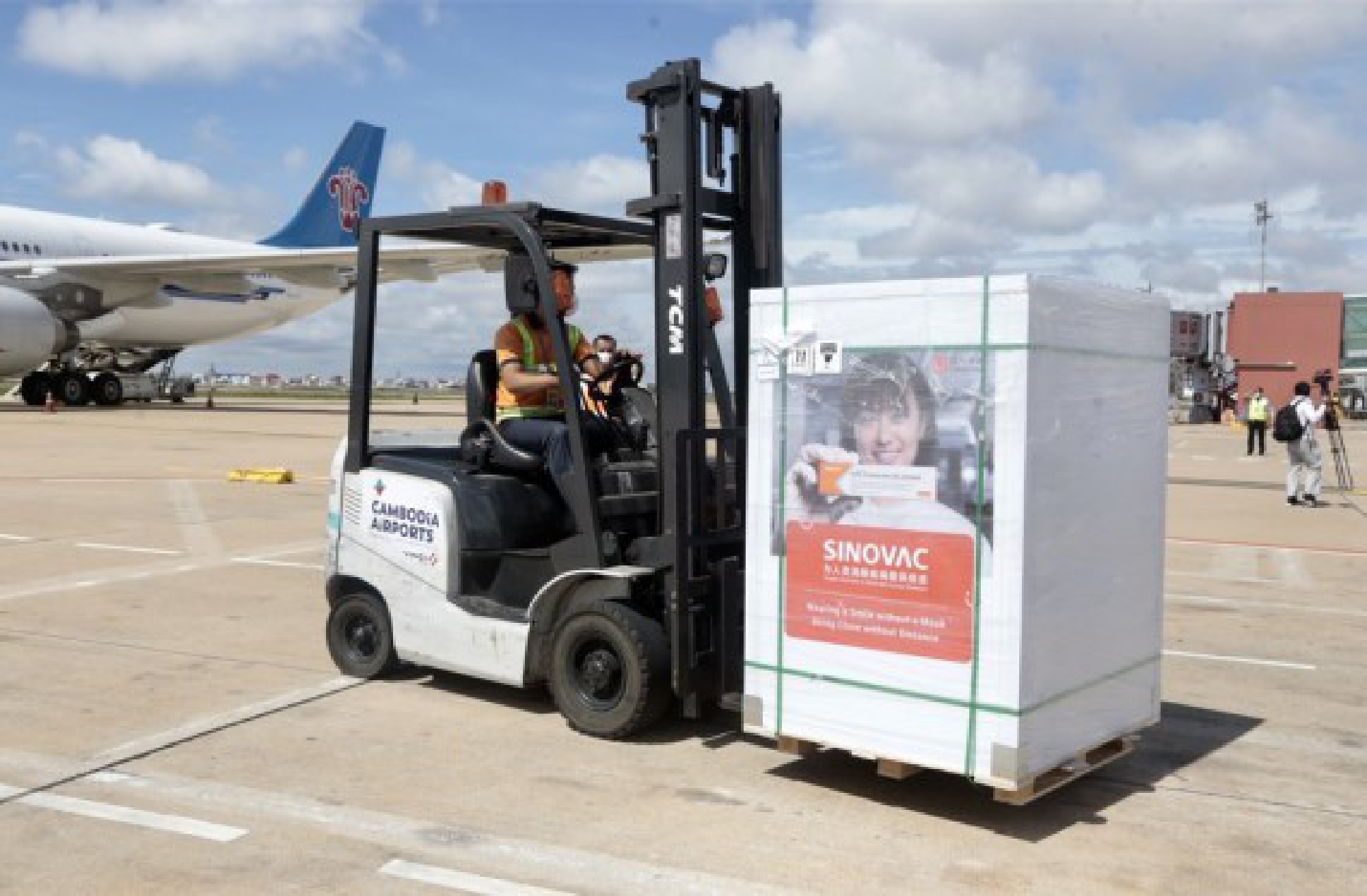 An airport worker transports packages of Chinese COVID-19 vaccine at the Phnom Penh International Airport in Phnom Penh, Cambodia on July 10, 2021.