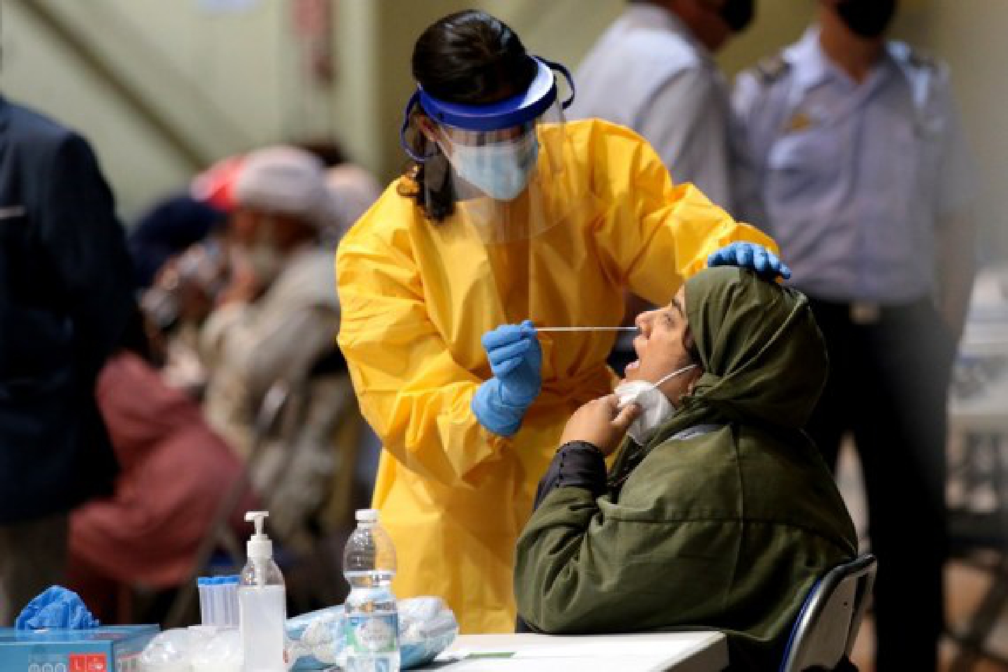 An Afghan woman evacuated from Afghanistan by a Spanish military plane receives PCR test in Madrid, Spain, on Aug. 19, 2021. 