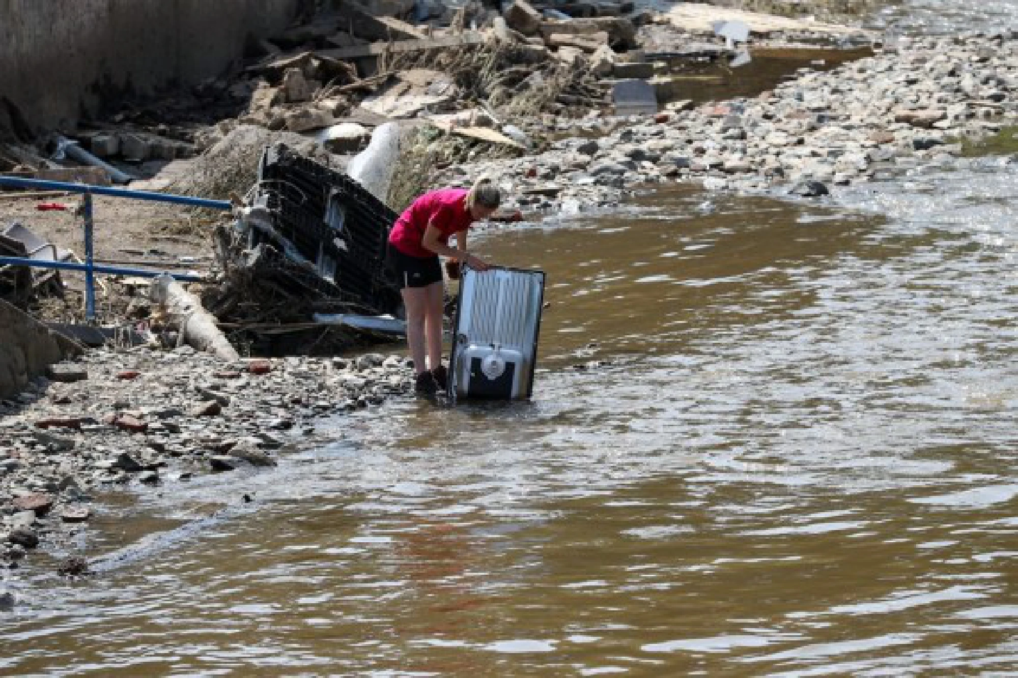 A resident cleans furniture in Pepinster, Belgium, July 20, 2021. Belgium is affected by floods and clean-up is under way to help the hard-hit regions recover from the destructions. 
