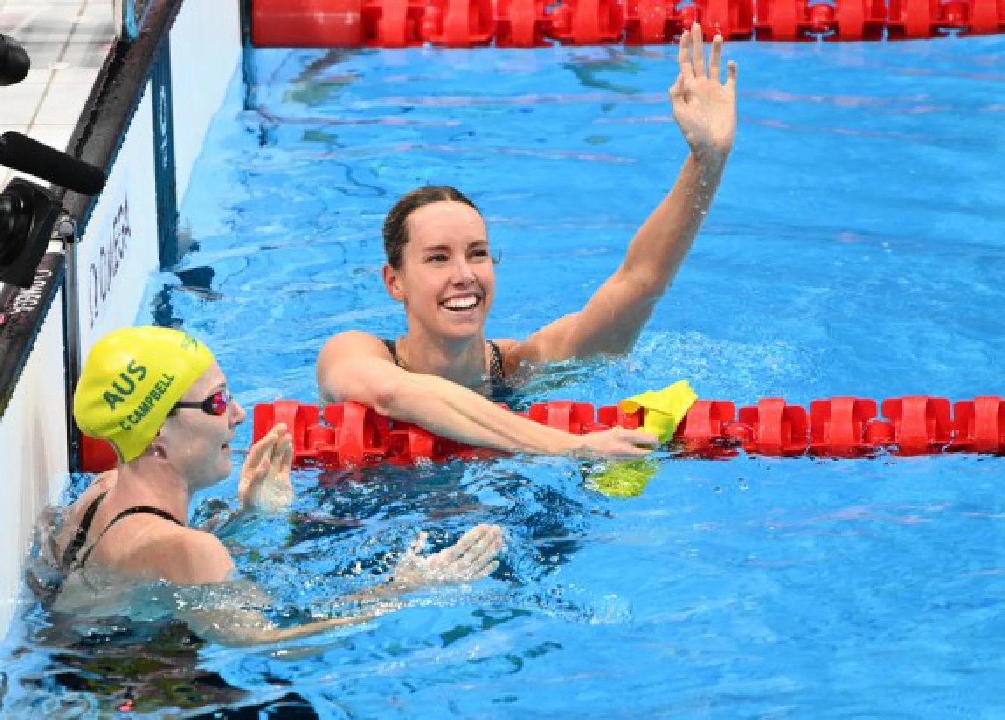 Emma Mckeon (R) of Australia celebrates after the women's 100m freestyle final on July 30, 2021.