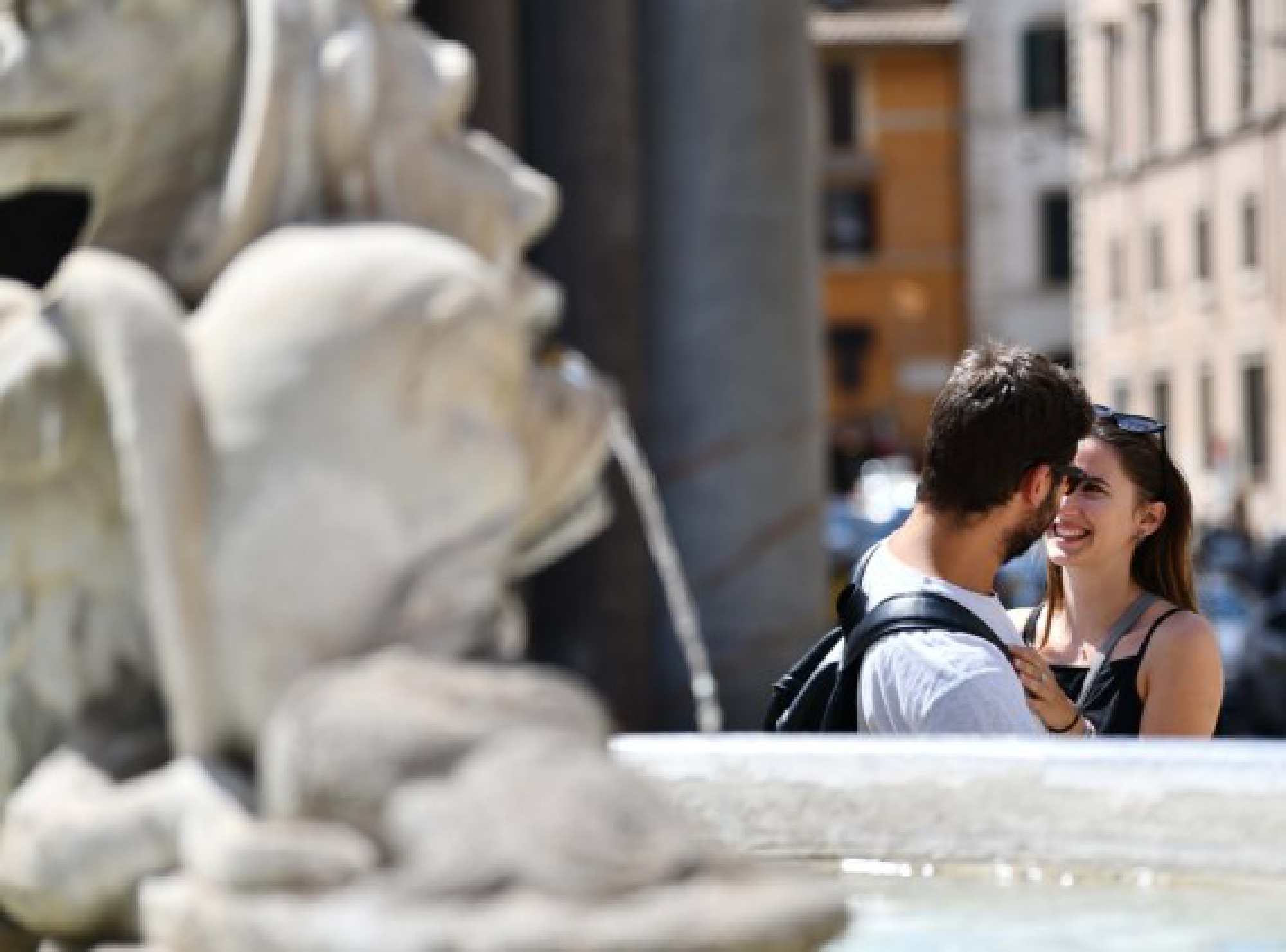 A couple stand near a fountain in Rome, Italy, Aug. 12, 2021. 