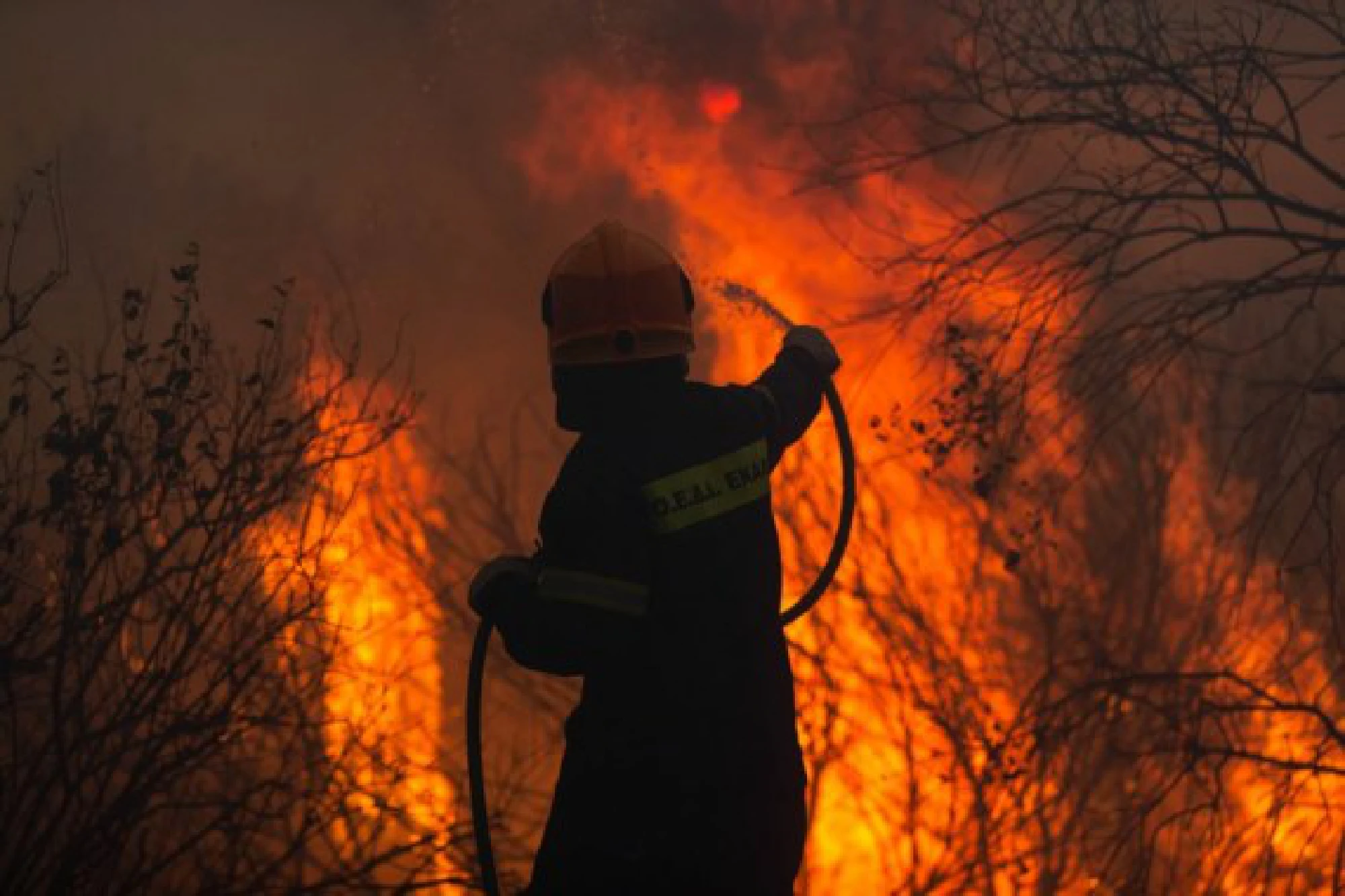 A firefighter battles against a wildfire at Varybobi, Acharnes, Greece, on Aug. 3, 2021. 