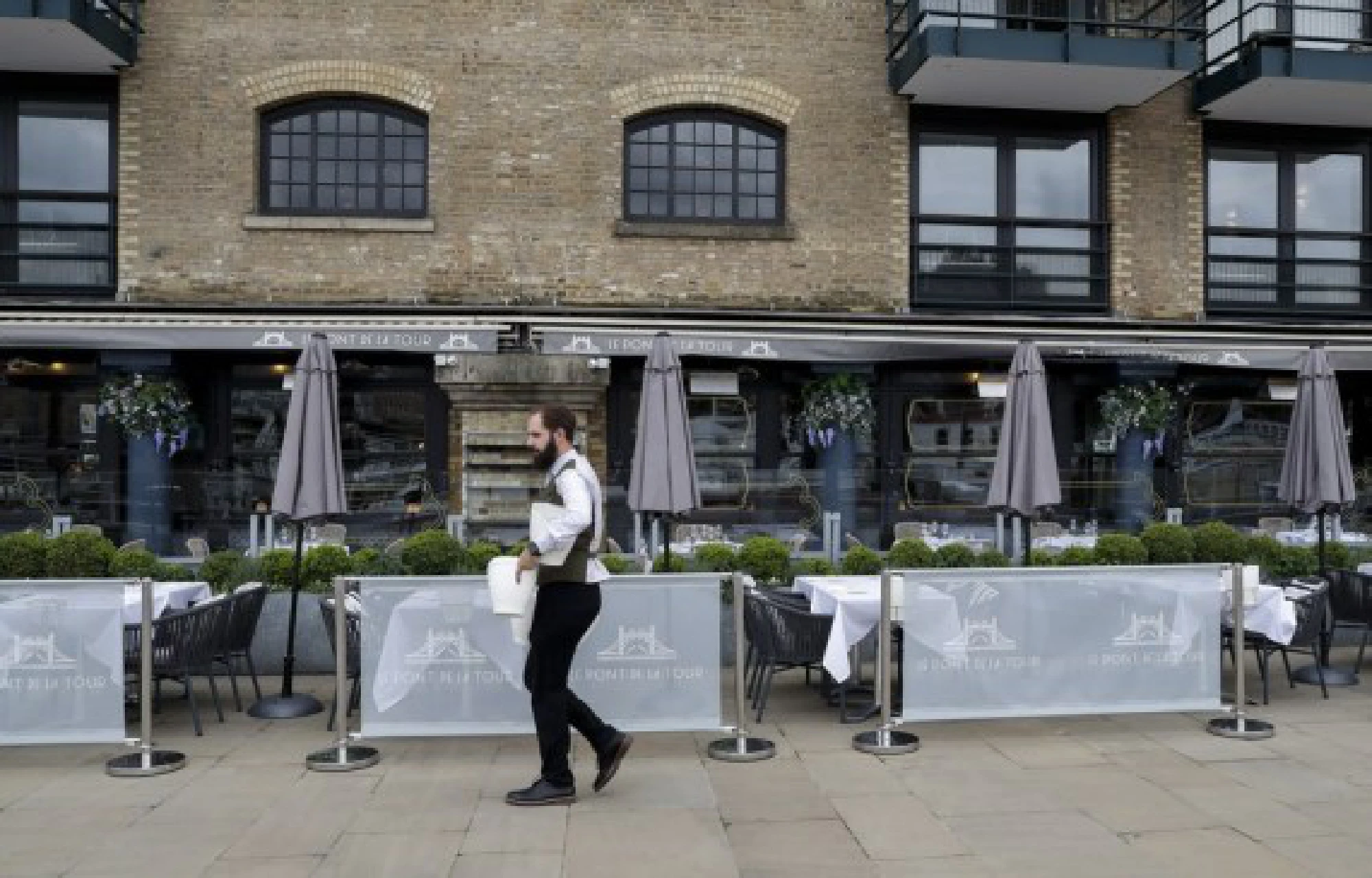 A waiter is seen at a restaurant in London, Britain, on Aug. 13, 2021.
