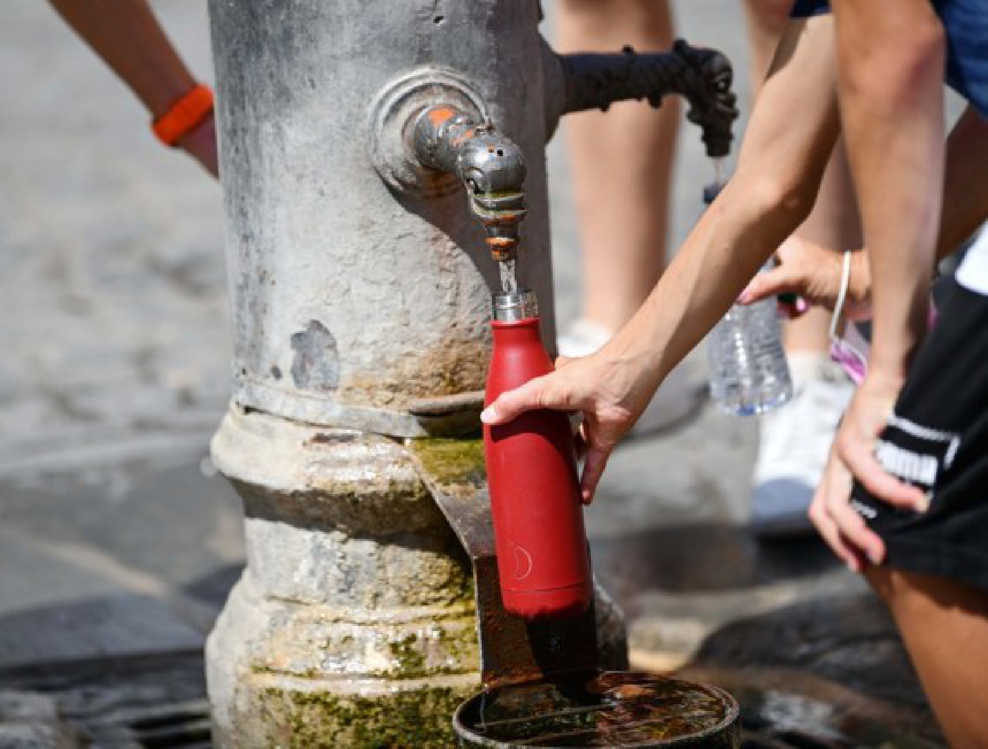  Tourists fill bottles from a water tap near the Pantheon in Rome, Italy, Aug. 12, 2021.