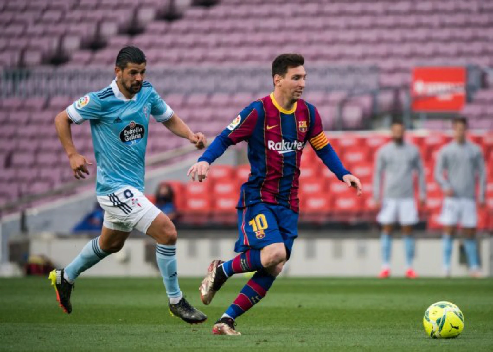 Barcelona's Lionel Messi (R) vies with Celta's Nolito during a Spanish league football match between FC Barcelona and Celta Vigo in Barcelona, Spain, on May 16, 2021. 