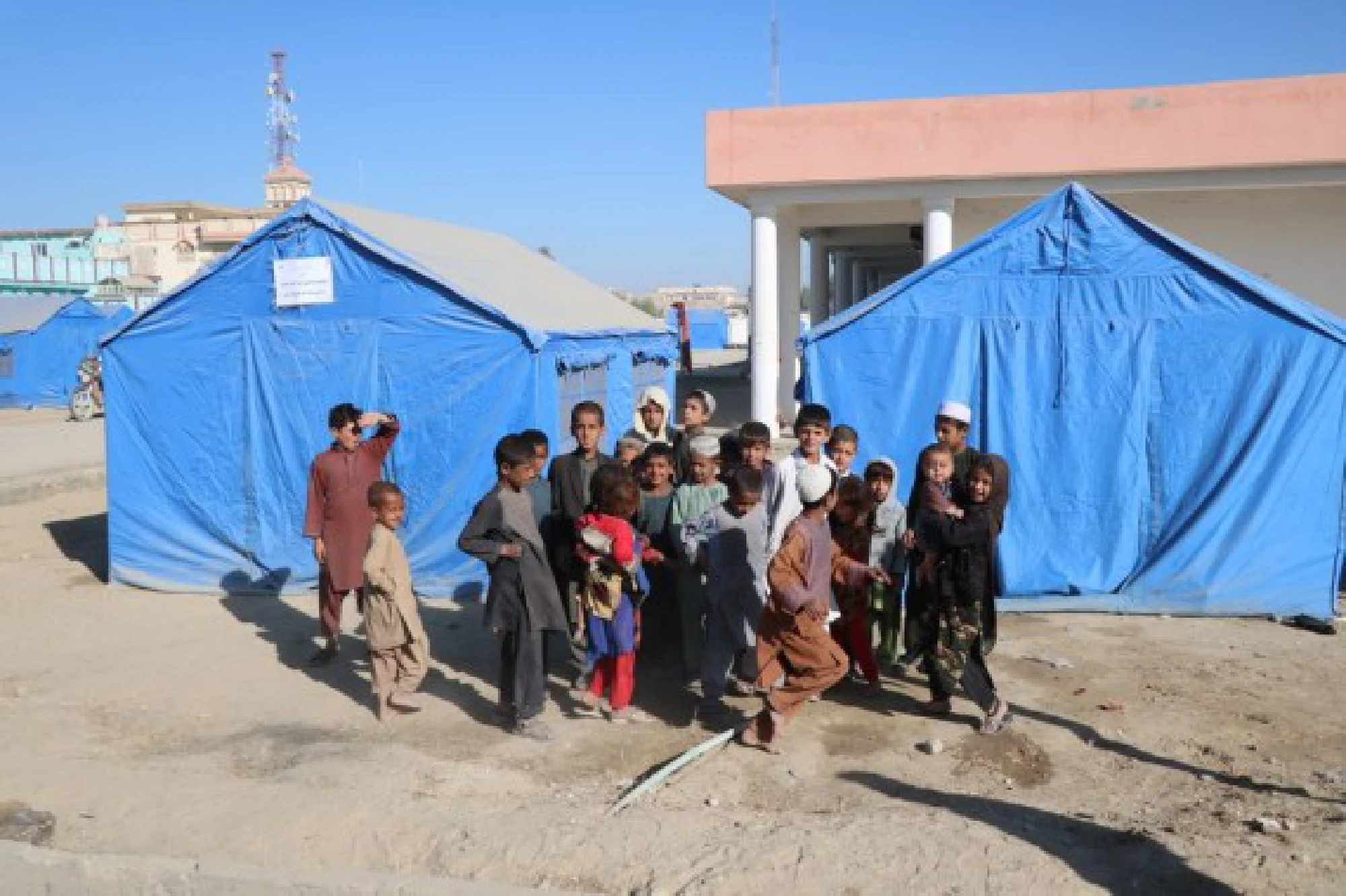 Children pose for photos at a camp for displaced people in Lashkar Gah, capital of Helmand province, Afghanistan, Oct. 28, 2020. 