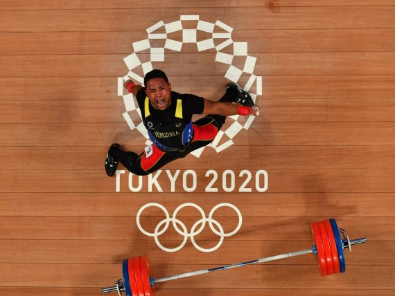 Keydomar Giovan Vallenilla Sanchez of Venezuela celebrates during the weightlifting men's 96kg event at Tokyo 2020 Olympic Games in Tokyo, Japan, on July 31, 2021. 